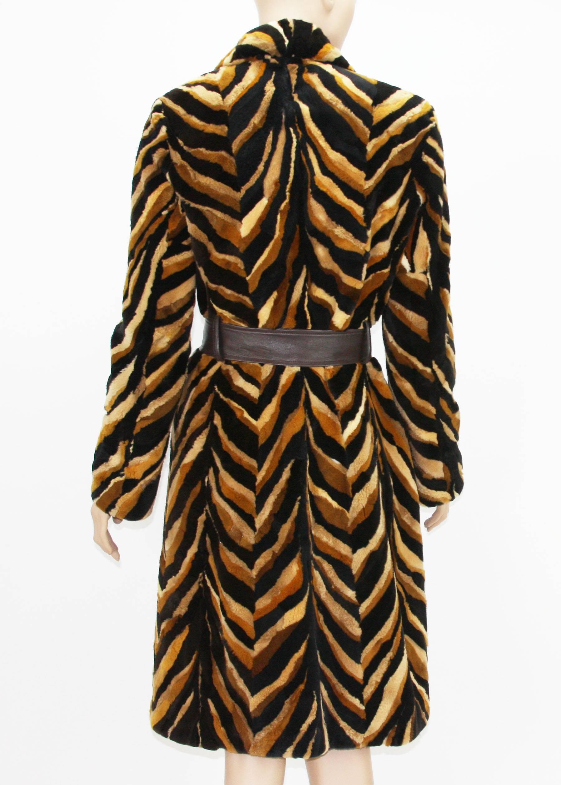 Intricately detailed coat constructed with different shades of mink (black, browns, tan) forming a large chevron pattern.
Vintage Gianni Versace Couture Sheared Mink Belted Coat. Italian size - 42.
89% Mink, 11% Leather. Fully Lined in brown lining