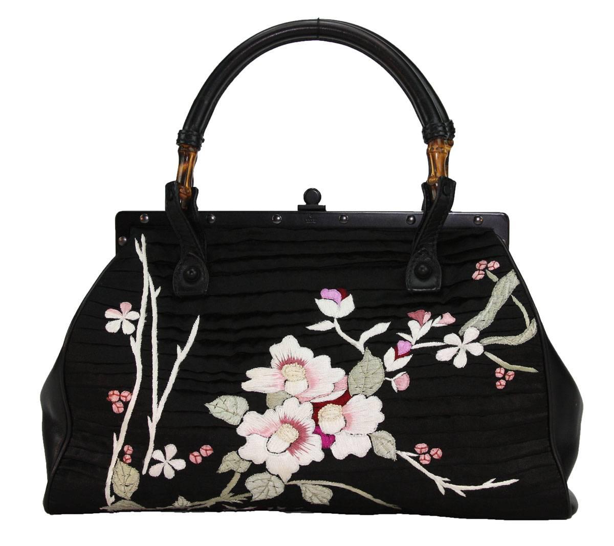 TOM FORD for GUCCI BLACK SILK FRAME JAPANESE FLOWERS BAG
S/S 2003 COLLECTION
RARE and COLLECTIBLE
COLOR – BLACK
SILK, LEATHER, BAMBOO
FLORAL JAPANISE EMBROIDERY IN WHITE, PINK, RED, GREEN ON BOTH SIDES
LEATHER SIDE PANES
FRAME-SHAPED