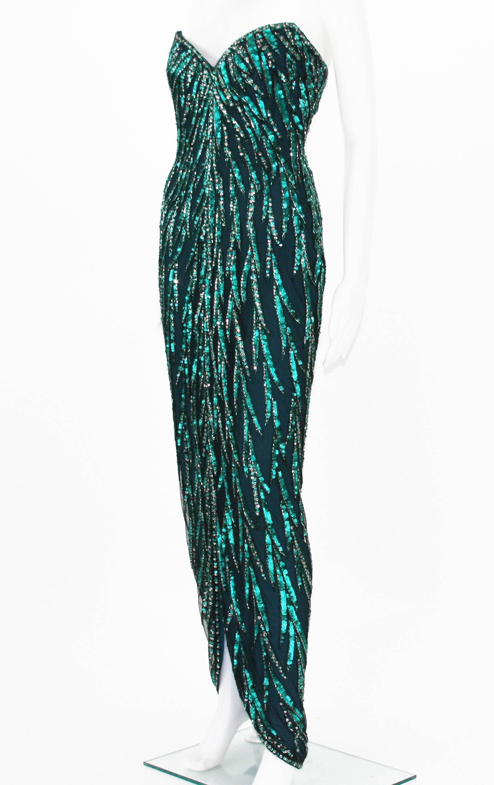 Vintage Bob Mackie Fully Beaded Evening Dress Gown
Green and Silver Beads and Sequins Over the Black Tulle, Built in Corset, Fully Lined, Back zip Closure.
Size Label Missing. Measurements: Length - 50 inches (from under the arm and down), Bust -