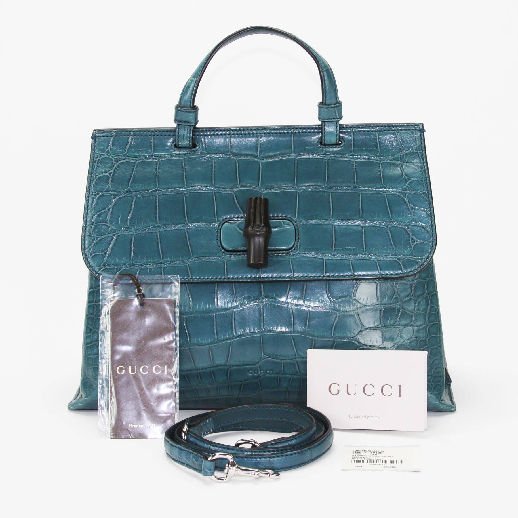 New Gucci Crocodile Bamboo Top Handle Bag with Shoulder Strap
F/W 2017 Collection, Size Medium.
Dusty Turquoise Crocodile Leather, Top Handle Bag with Removable Crocodile Shoulder Strap, Bamboo Turn-lock Closure, Silver-tone Hardware, Interior Zip