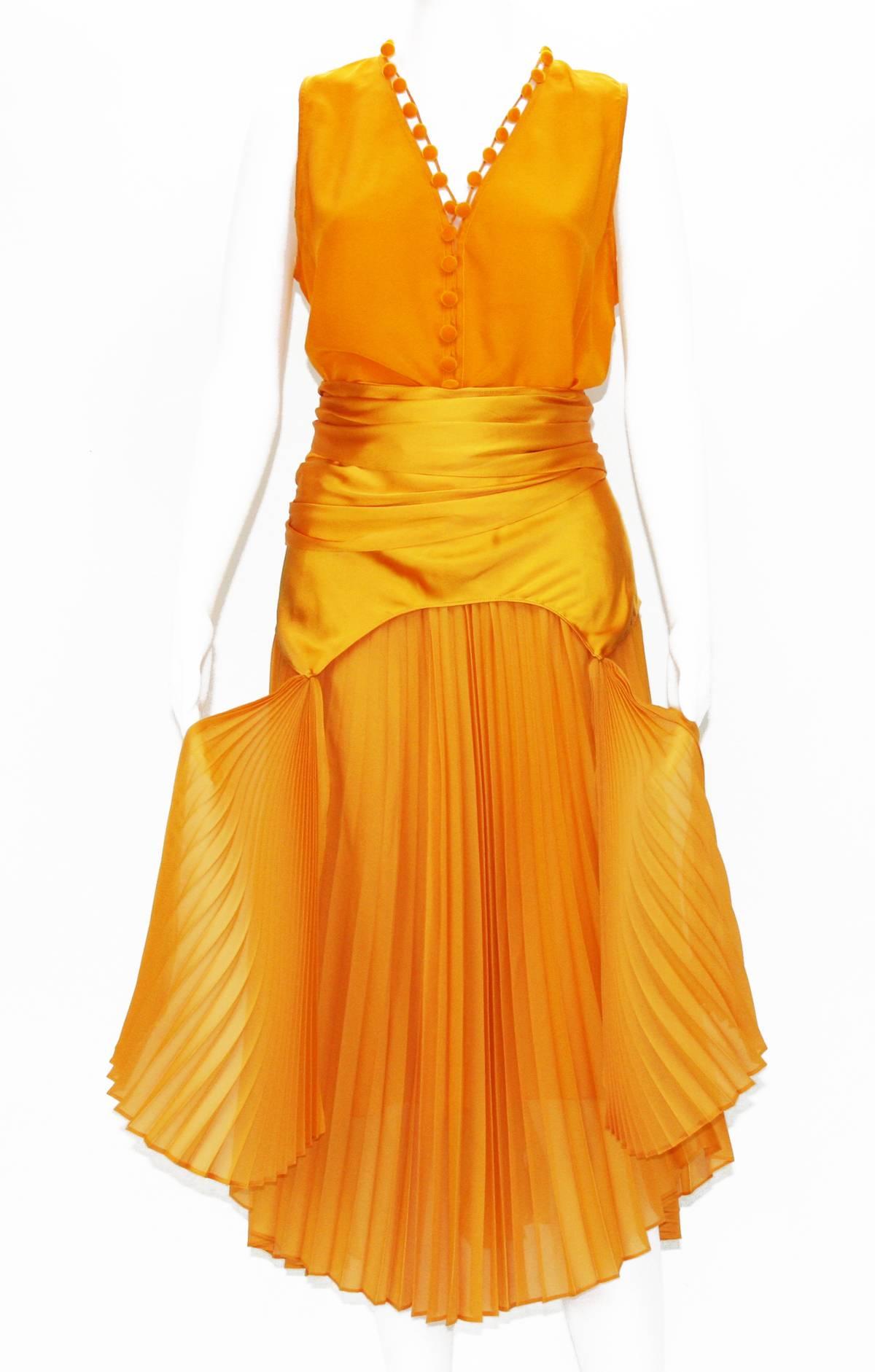 Tom Ford for Yves Saint Laurent Silk Orange Top Skirt Set 
S/S 2004 Collection
100% Orange Silk
Top - French size 38, Velvet Buttons Closure, New with Tag.
Measurements: Length - front (26 inches) , back (29), Bust - 36.
Skirt - French size 40,