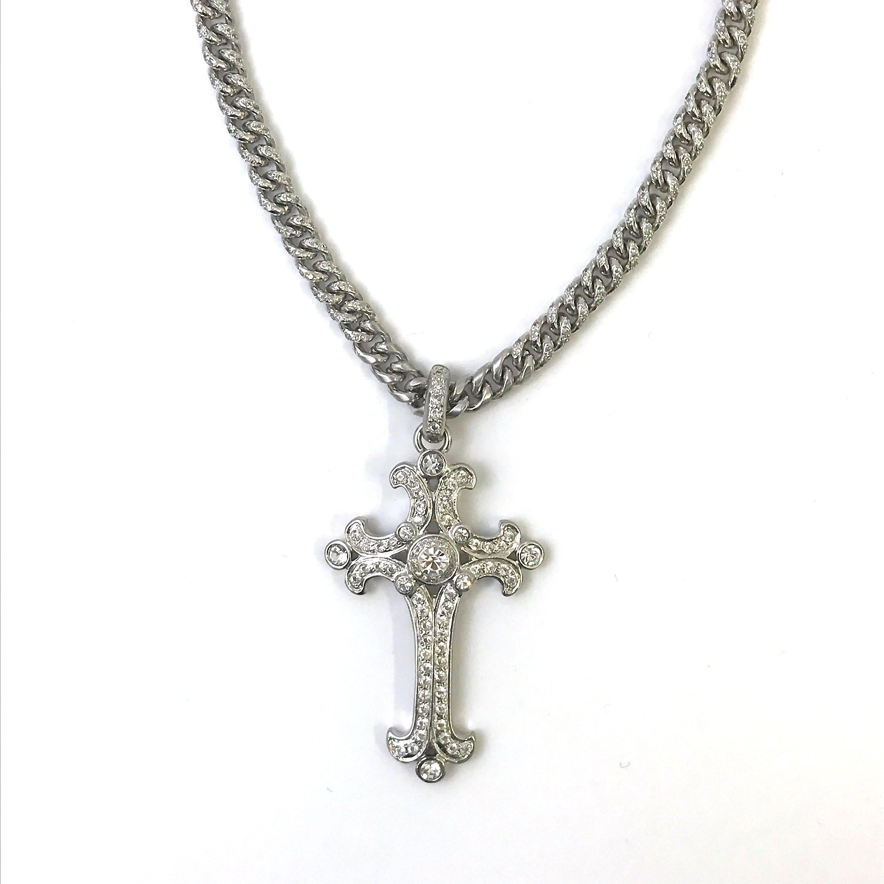 This 1990's Gianni Versace cross pendent necklace is masterpiece whilst offering a timeless classic style. The silver tone metal curb chain has a beautiful stone detail towards the pendant and the rest of the chain has a subtle brushed and polished
