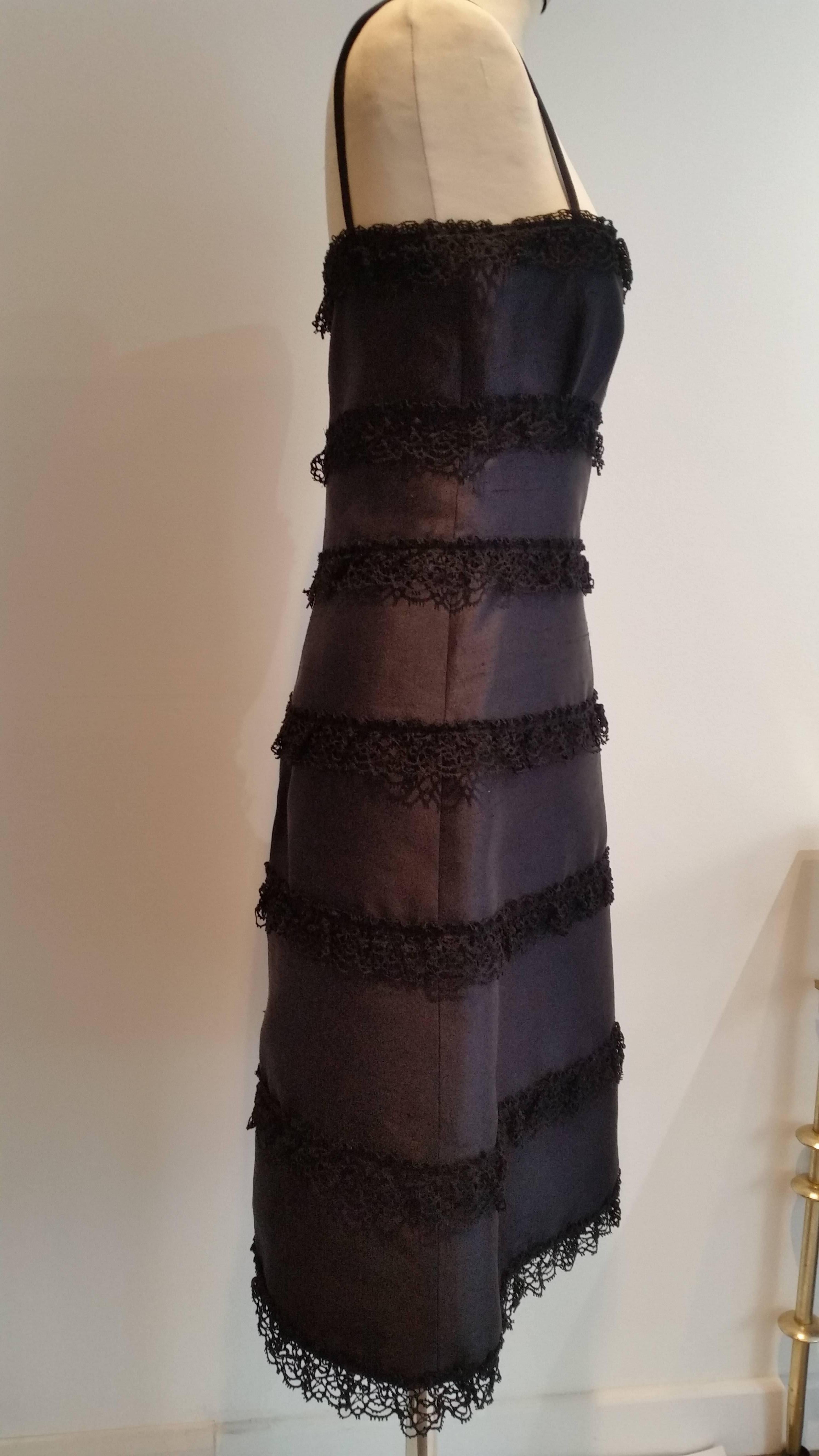Valentino iconic little black dress. 
Shoe string straps.
Back hidden zip
Fully lined with black silk.
Panels of silk with lace edging
Very Audrey Hepburn....

Made in Italy



Measurements
Bust 32 inches
Length 30 inches (underarm to hem)


