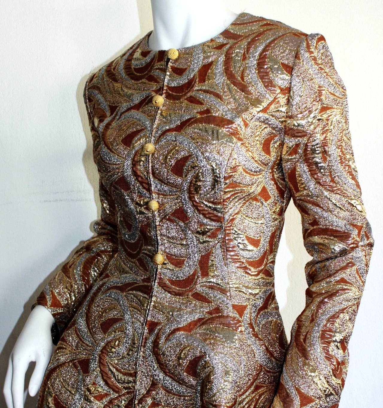 Amazing vintage 1960s Richard Tam dress! Beautiful swirls of bronze, silver, and gold, with gold thread balls down the bodice. Zips up the front. Statement flounce skirt that looks great on the dance floor. Fully lined. Richard Tam and Neiman Marcus