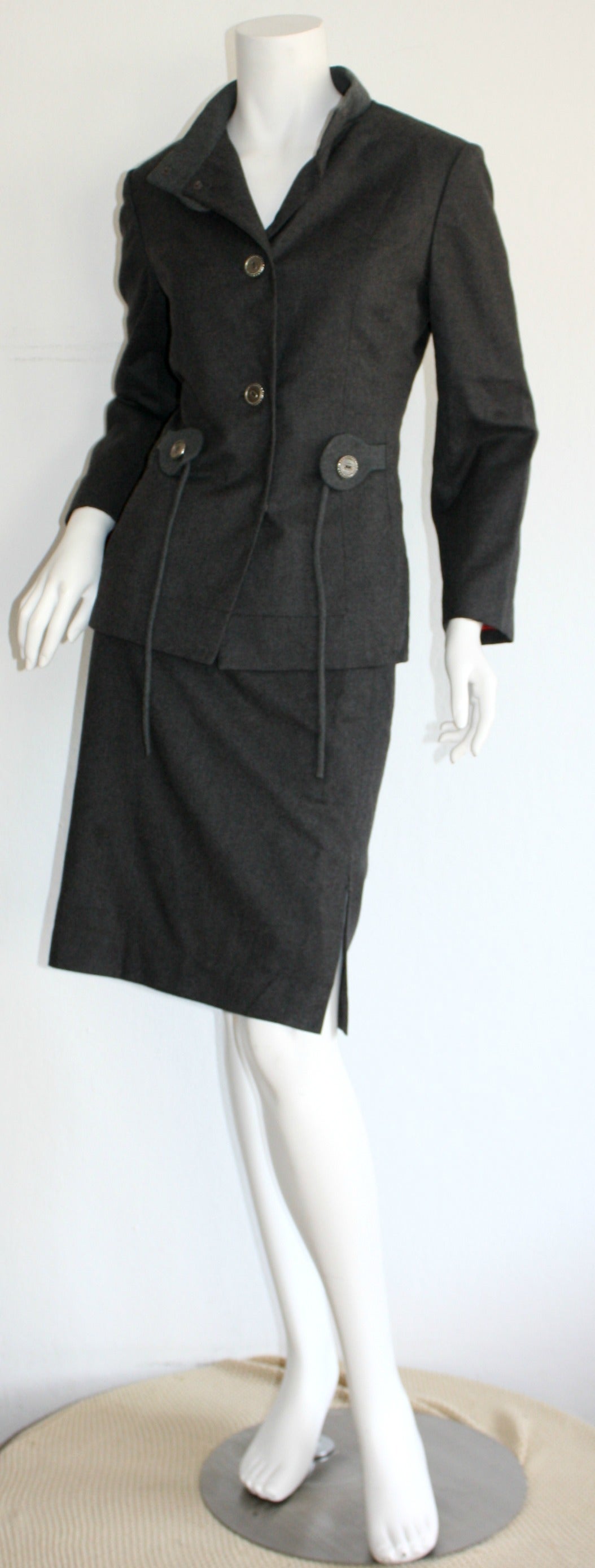 Striking vintage 1940s Don Loper of Beverly Hills skirt suit. Features silver buttons up the bodice, and inner snaps at collar. Matching wool ribbon attached at the waist to tie into a bow, or leave down. High-waisted pencil skirt. Incredible fit,