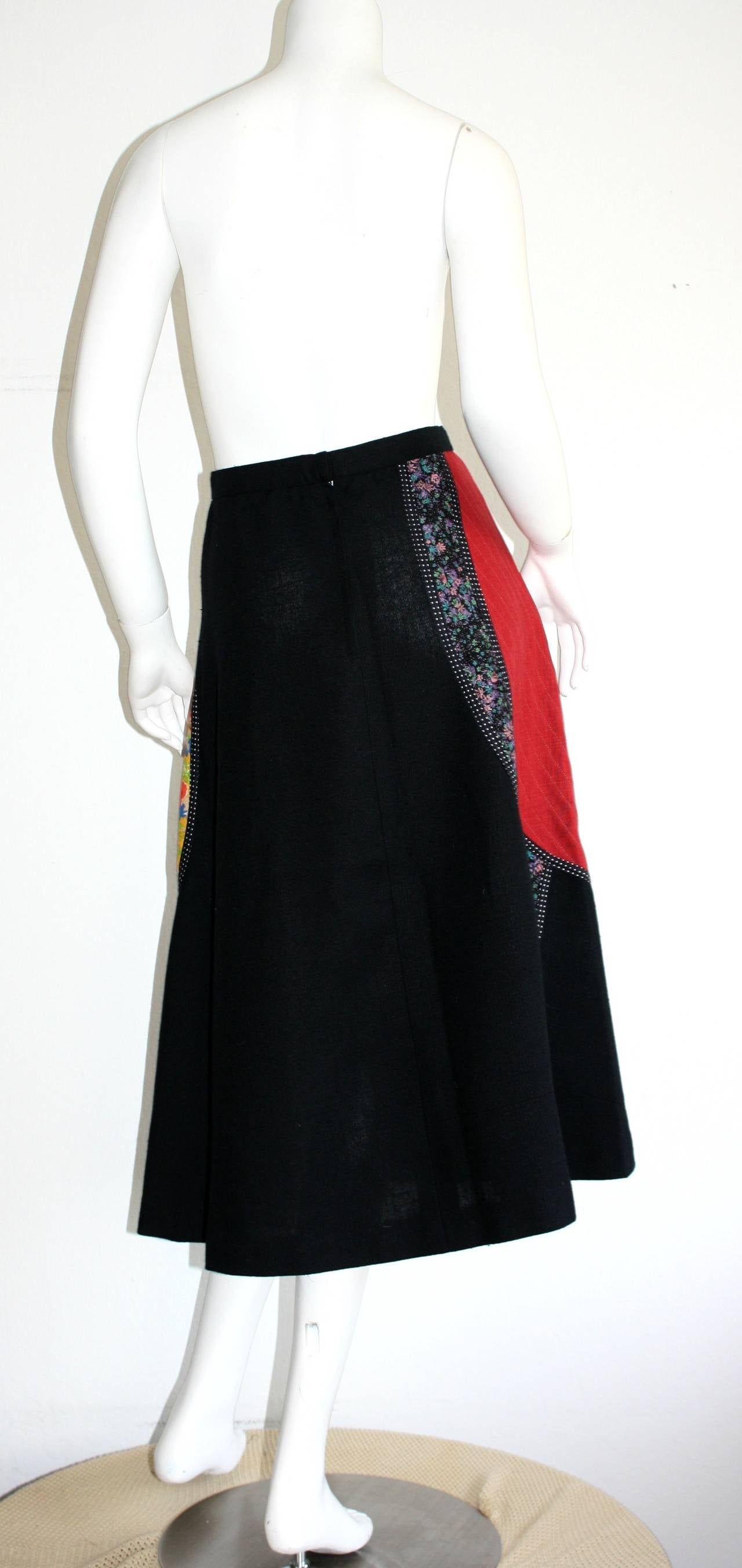 Cutest vintage Koos Van Den Akker boho patchwork skirt! Heavy black cotton, with a floral patchwork horseshoe 'U' shape. An easy piece to dress up or down! Looks great, belted with a white collared blouse, or perfect with a tank and boots. In great