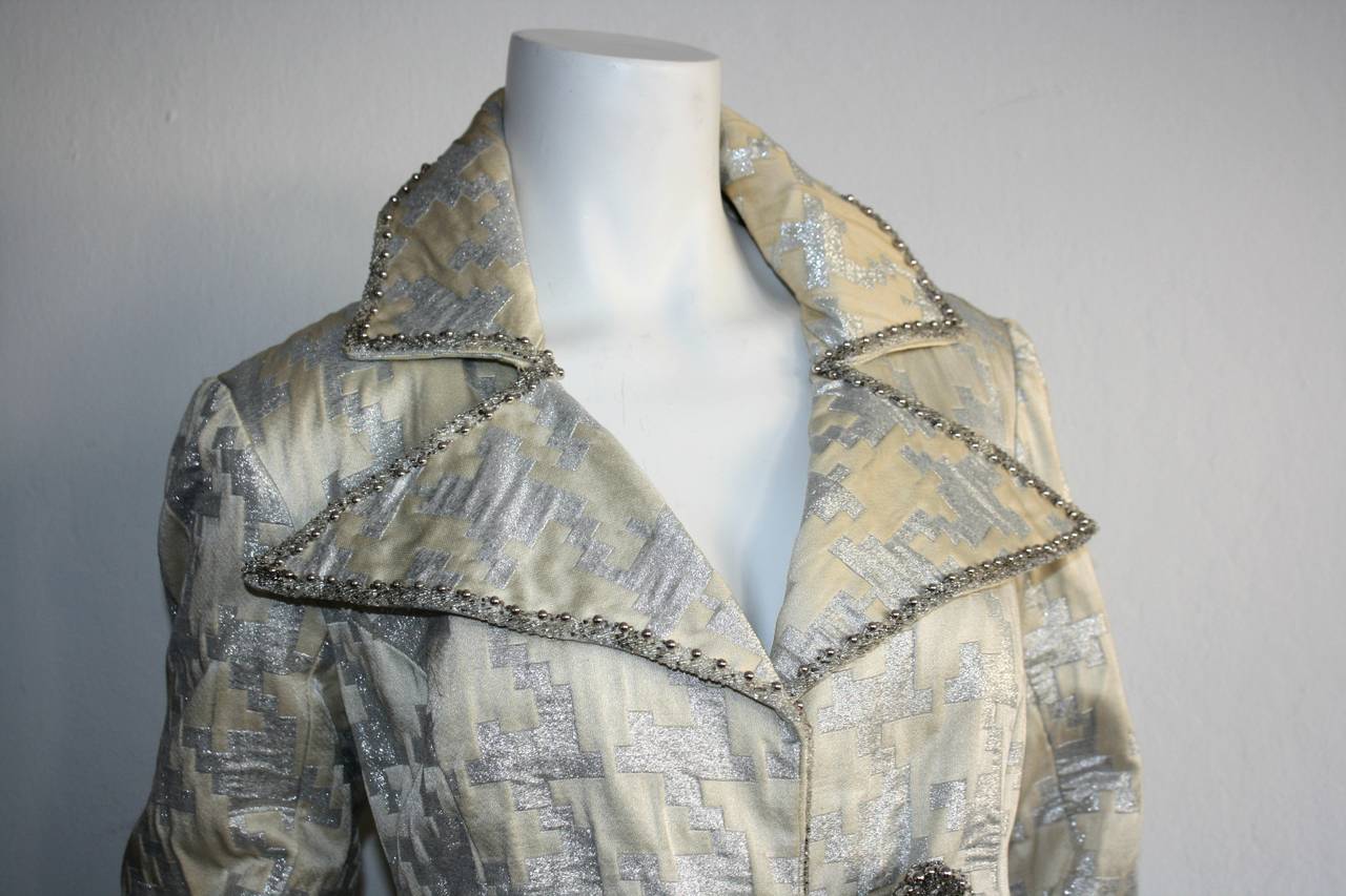 Gorgeous vintage 1960s silver and ivory metallic houndstooth princess jacket. Features silver beading throughout collar and cuffs. Intricate beaded closure, with matching detail on the back. Constructed extremely well--There is significant weight to