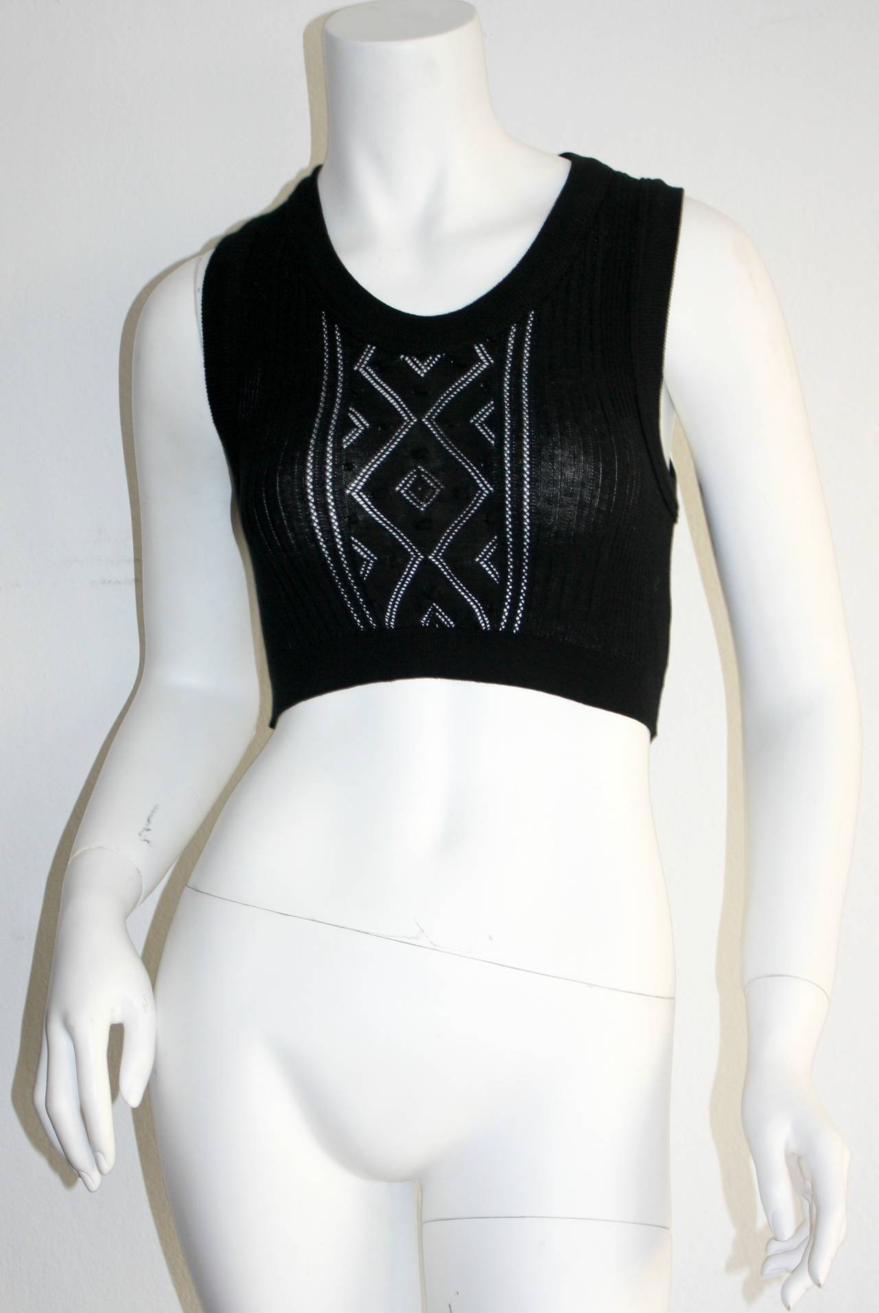 Sexy vintage Jean Paul Gaultier black geometric cut-out crochet crop top. A great piece, with intricate stitching detail. Signature loop at back neck. In great condition--Appears to never have been worn.

Measurements: (Features stretch)
30-38