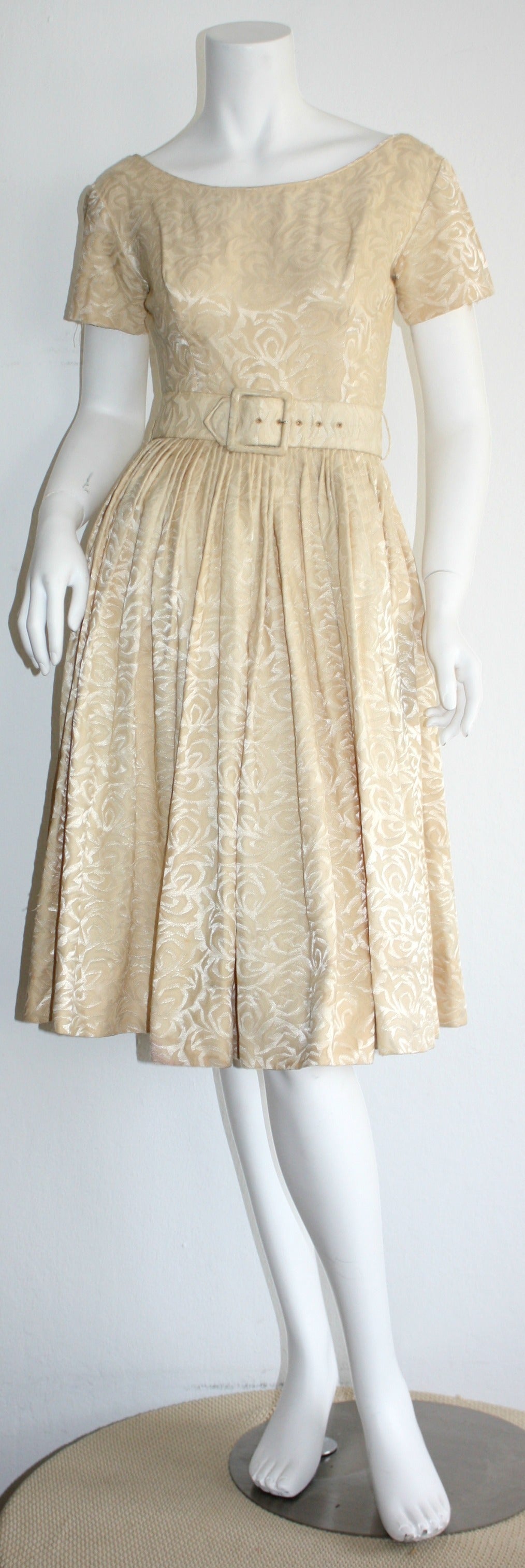 Wonderful vintage 1950s Gigi Young ivory silk dress, with floral background motif. Features detachable belt. Flattering full skirt, that looks great on the dance floor! Also room for a crinoline. Such a pretty, and versatile dress! In great