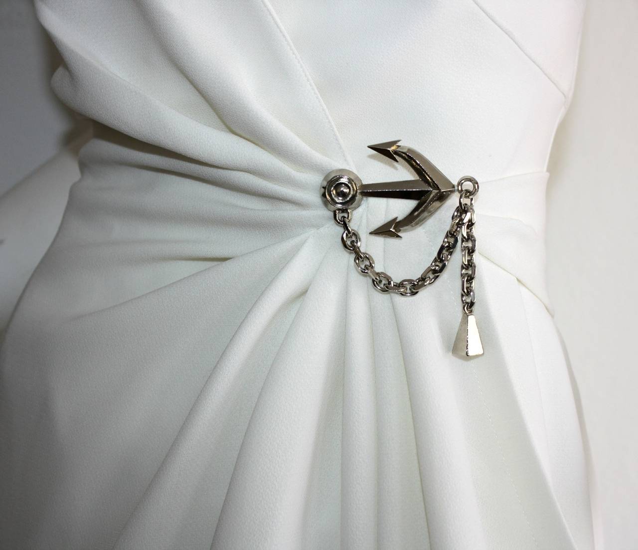 Incredible vintage 1990s Thierry Mugler stark white wrap dress. Signature lapels, with amazing draping that flatters many body shapes. Beautiful silver Anchor and chain detail at side waist. Intricate detail on back. Fully lined. In great condition,