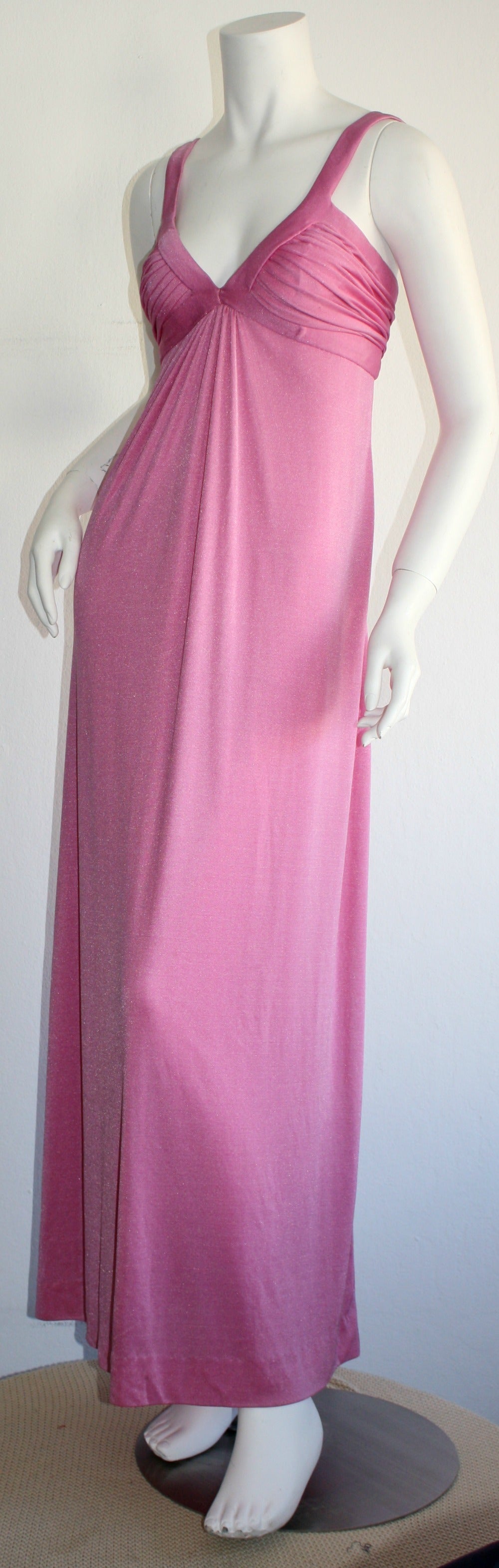 Stunning vintage 1970s Loris Azzaro pink silk jersey gown! Beautiful bodice, with a draped, Grecian/Empire feel to the body. Zipper works great, just could not fit the dress form. In great condition. Made in France
Approximately Size