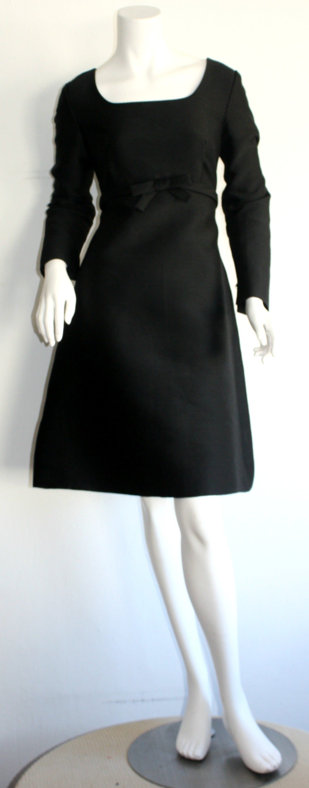 The perfect 1960s SUZY PERETTE vintage little black dress! This Perette number is an easy, extremely flattering piece! Mock bow at empire waist, with a dramatic bell hem. Amazing raw silk that holds shape! Fully lined. In great condition.