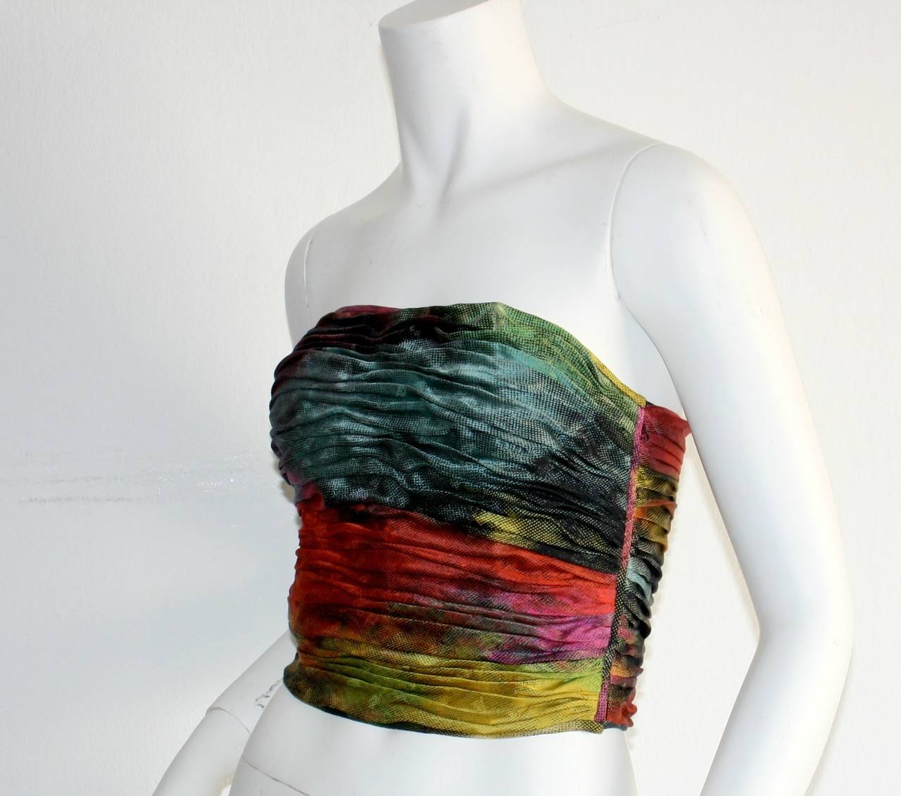 Gorgeous vintage Emaunel Ungaro silk ruched bustier blouse! Obre effect, with slimming detail. Hidden zipper up the side. Fully lined. In great condition. Approximately Size Small

Measurements:
36-38 inch bust
26 inch waist