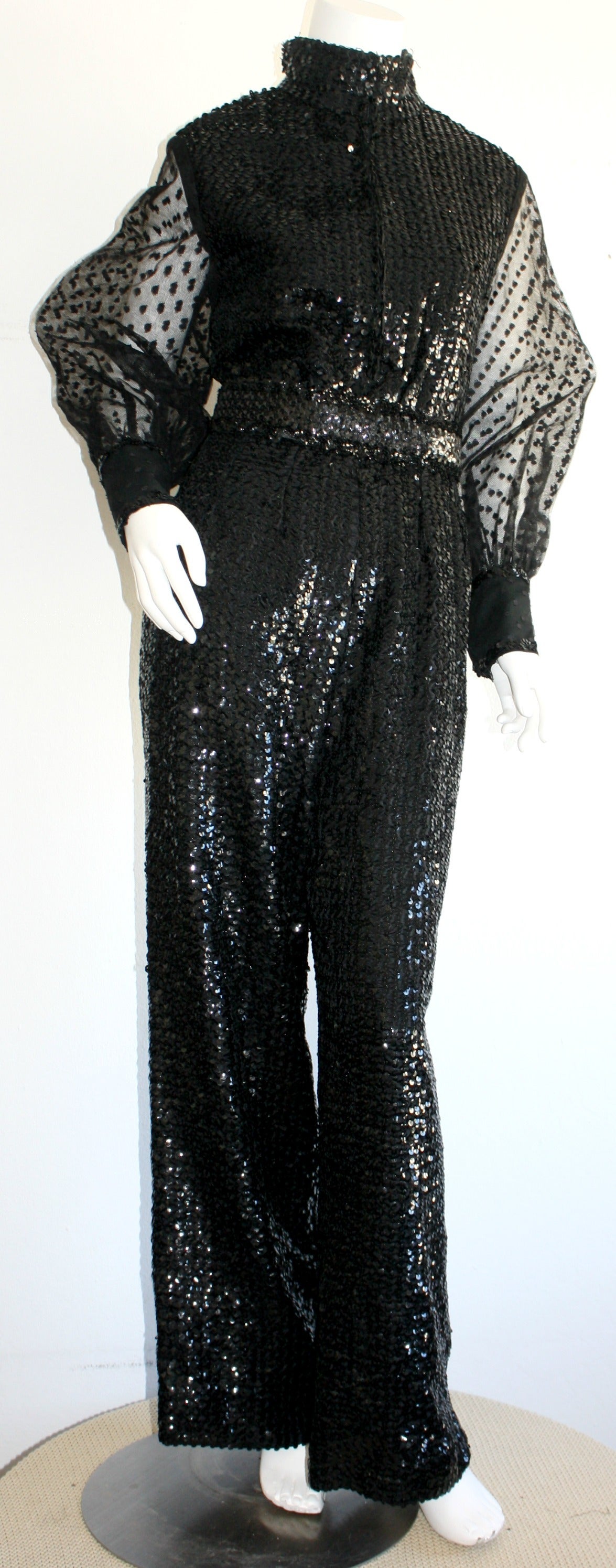 Extraordinary vintage 1970s Oscar de la Renta jumpsuit! Features all-over black sequins, with wonderful full lace sleeves. Three snaps at each cuff. Jumpsuit features full zips on both the front, and the back--Easy to control cleavage level.