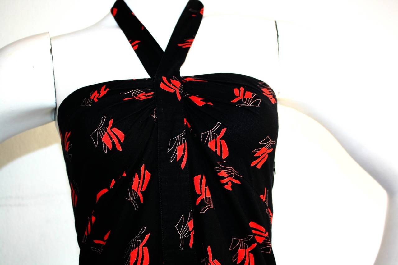 Gorgeous vintage Guy Laroche dress! Bold red oriental themed print, on black cotton. Chic halter neck, with a full skirt that will flatter all shapes. Easily transitions from day to night. Could easily add a crinoline under for a fuller skirt. Made