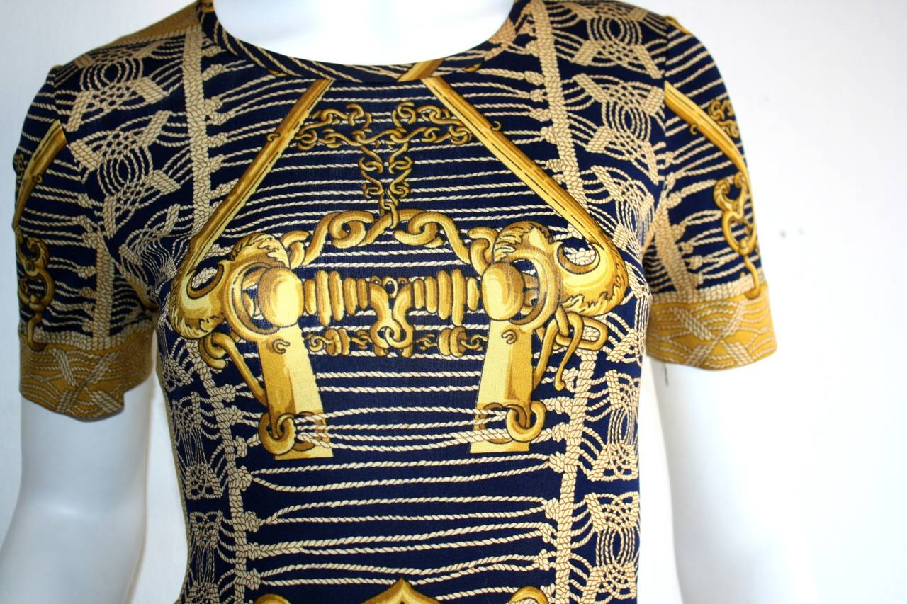 Wonderful 1970s Hermes silk jersey dress! Classic Hermes print in vibrant hues of blue and gold. Features Avant Garde oversized 