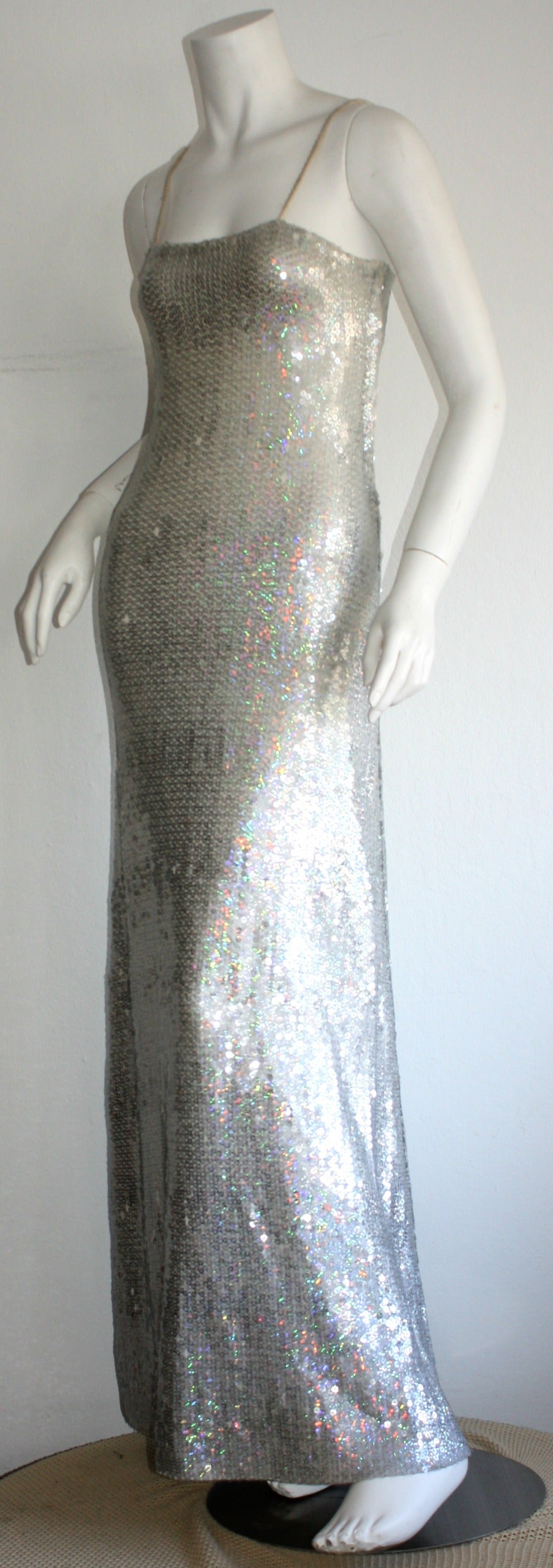 Stunning vintage 1970s Halston gown!!! Features all-over iridescent sequins. Beautiful silhouette, with a flowy mermaid hem. This is a true, rare beauty that is simply amazing on the body....Shimmers with every move! In good condition, with some