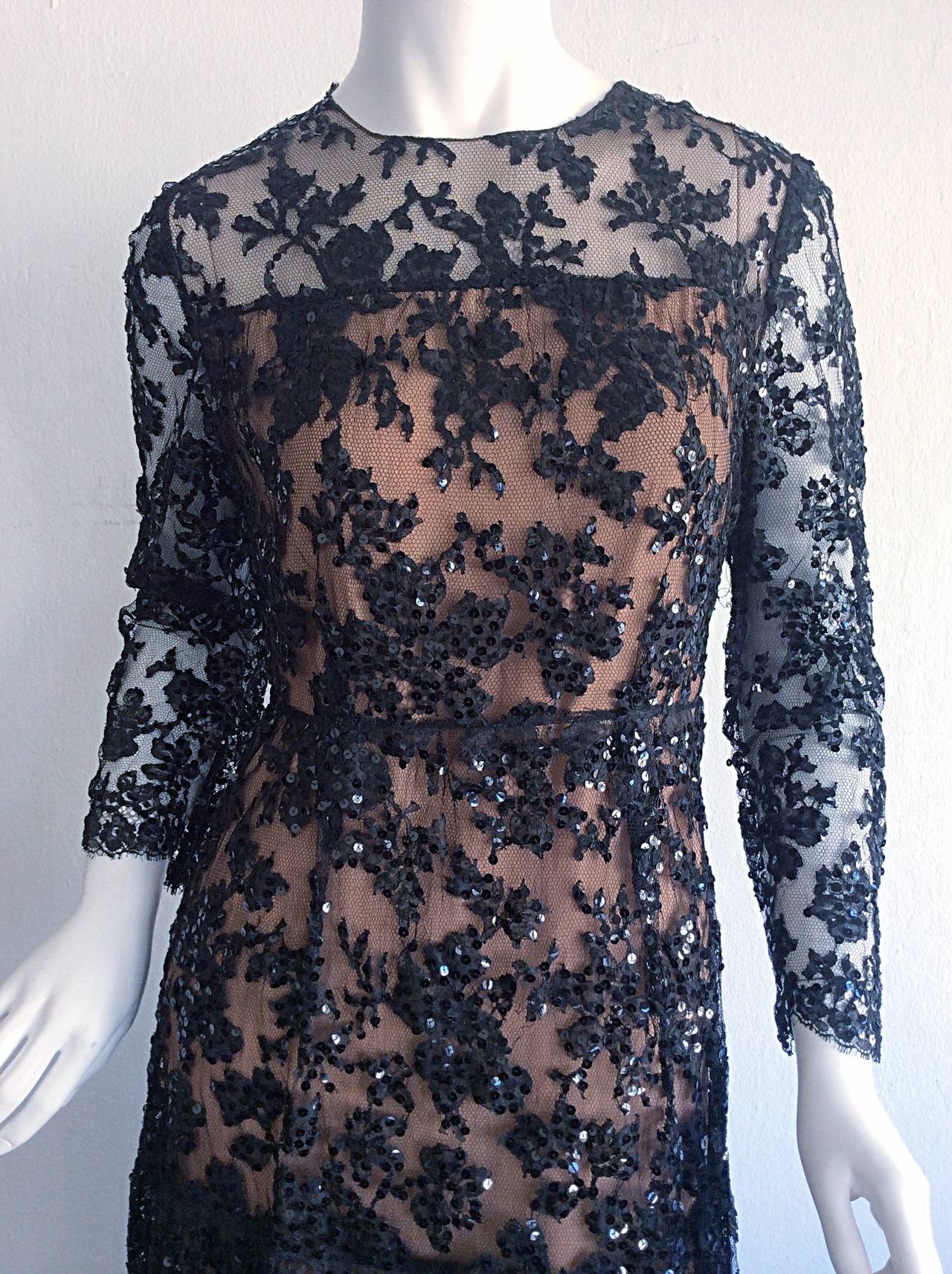 Such a stunning vintage 1960s Babydoll cocktail dress! Black French lace, covered with black sequins. Beautiful scalloped hems, with layers of nude silk under. Zips up the back, with hidden snaps up the back. Extremely well made. Such a pretty
