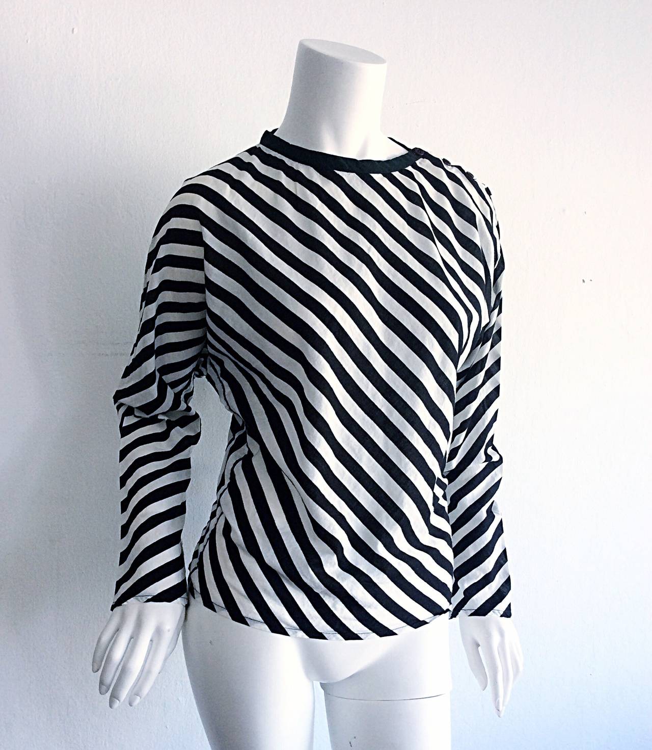 Only Koos Van Den Akker could create such a wonderful striped blouse. His pieces are being increasingly sought after, following his death earlier this month. Features buttons at collar, and dolman sleeves. 100% cotton. In great condition. Marked