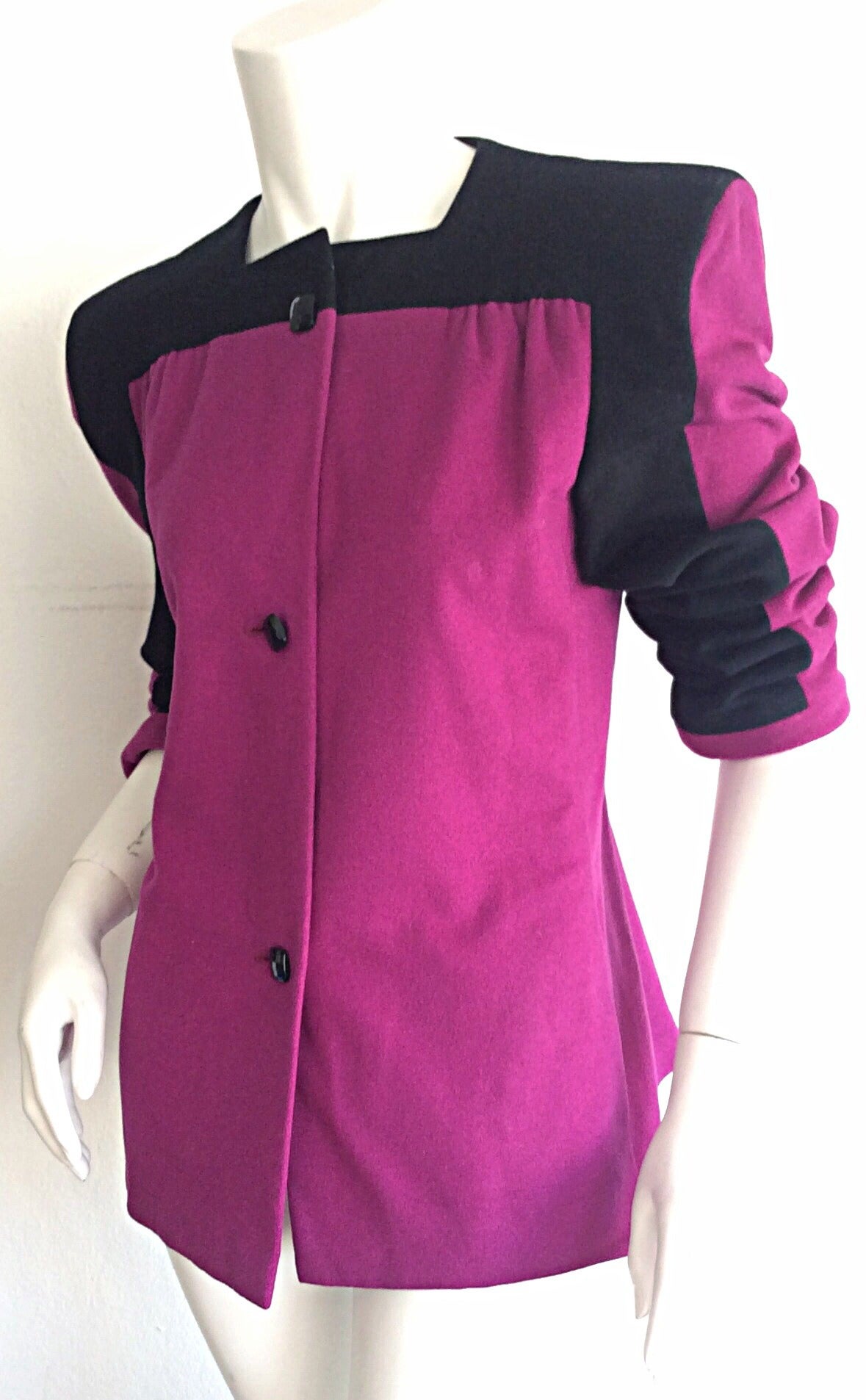 Stunning vintage Carolina Herrera color block jacket. Vibrant hues of fuchsia and black, with cubed black buttons up bodice. The perfect statement piece. Full lined. Approximately Size Medium-Large

Measurements:
38-40 inch bust
36 inch waist