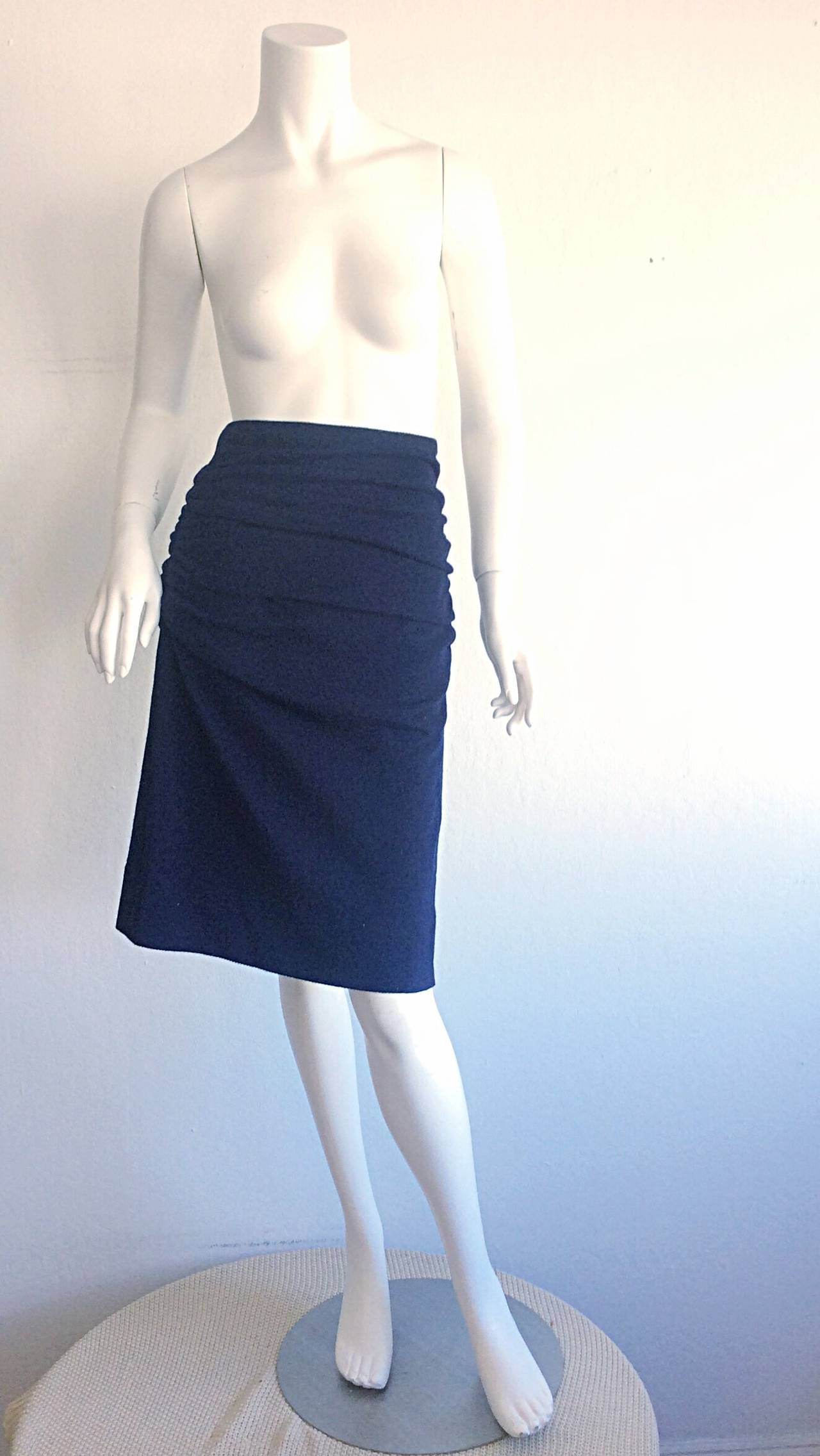 Figure flattering vintage Karl Lagerfeld navy skirt! Features ruching on front and back, with a slight asymmetrical hem. The finest of wools! Looks amazing on the body! Great with a sleek blouse and belt, or great with a blazer! Fully lined. Made in