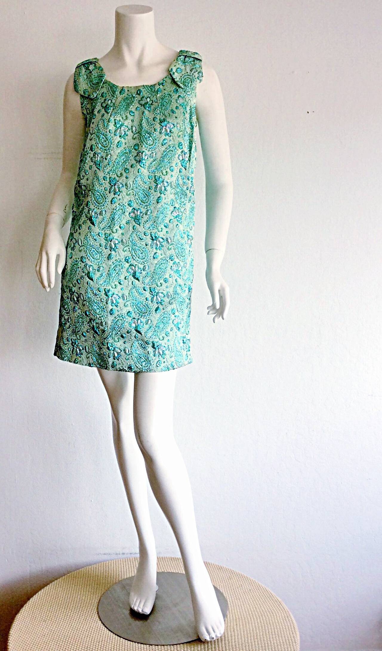 The cutest vintage 1960s metallic brocade paisley dress! Beautiful hues of blue, with metallic silk thread throughout. Wonderful petal sleeves. A truly flattering Babydoll fit. In great condition. Approximately Size XS-Small

Measurements:
32-34