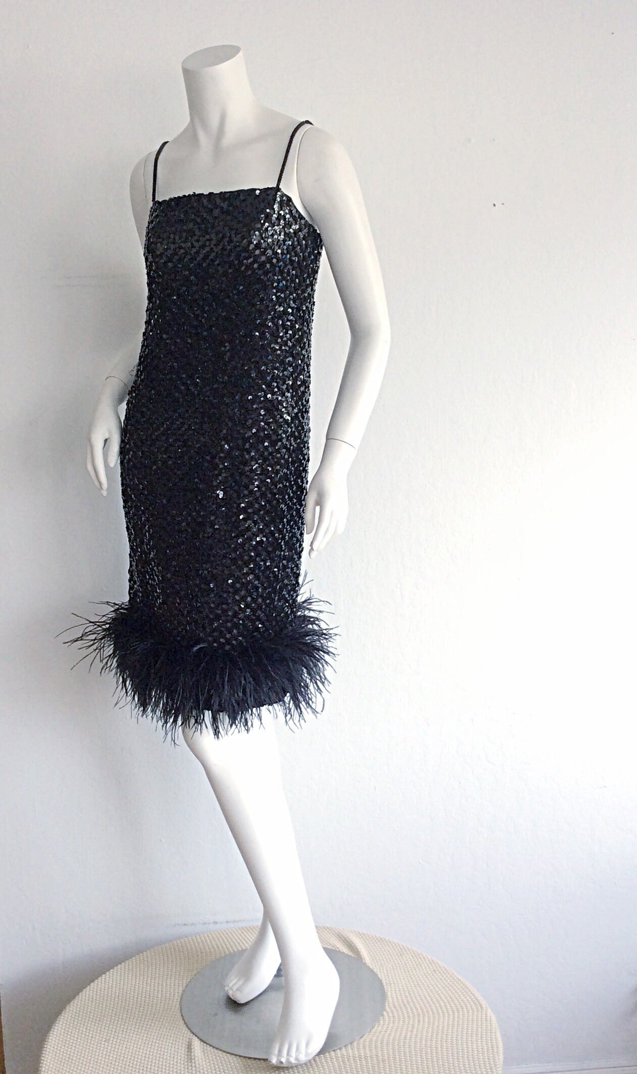 Stunning vintage I. Magnin 1960s black sequin dress, with ostrich feather hem! Beautiful nude chiffon double layer, that peeks through sequins. The perfect little black dress. Great alone, or belted. Perfect with heels, slides, or boots.  Metal