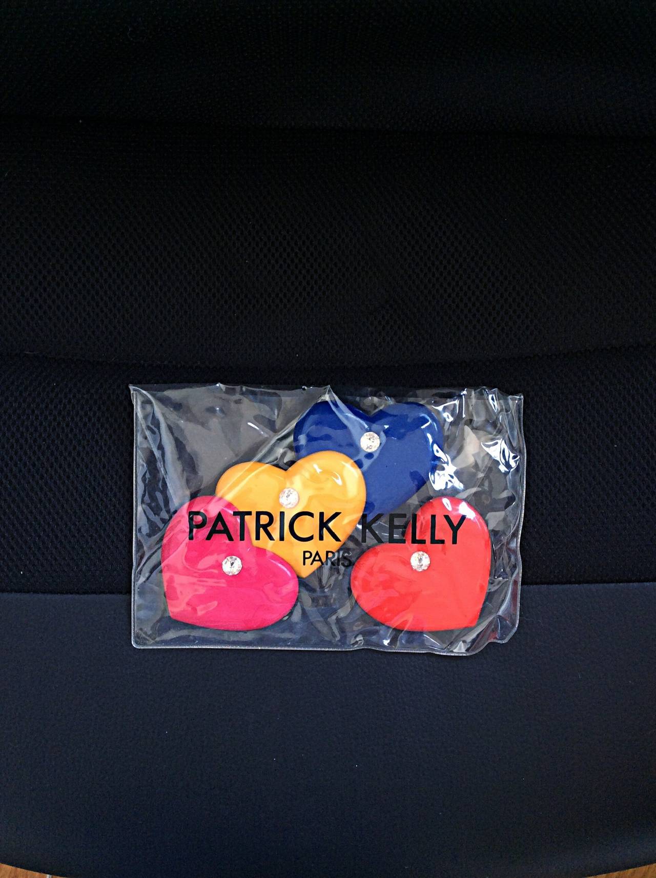 Rare set of four oversized heart pins/brooches by Patrick Kelly! Blue, pink, yellow and red, with large rhinestone in the middle. Perfect against a solid black dress, on a tee shirt, on a bag, etc....So many different uses! In great condition, with