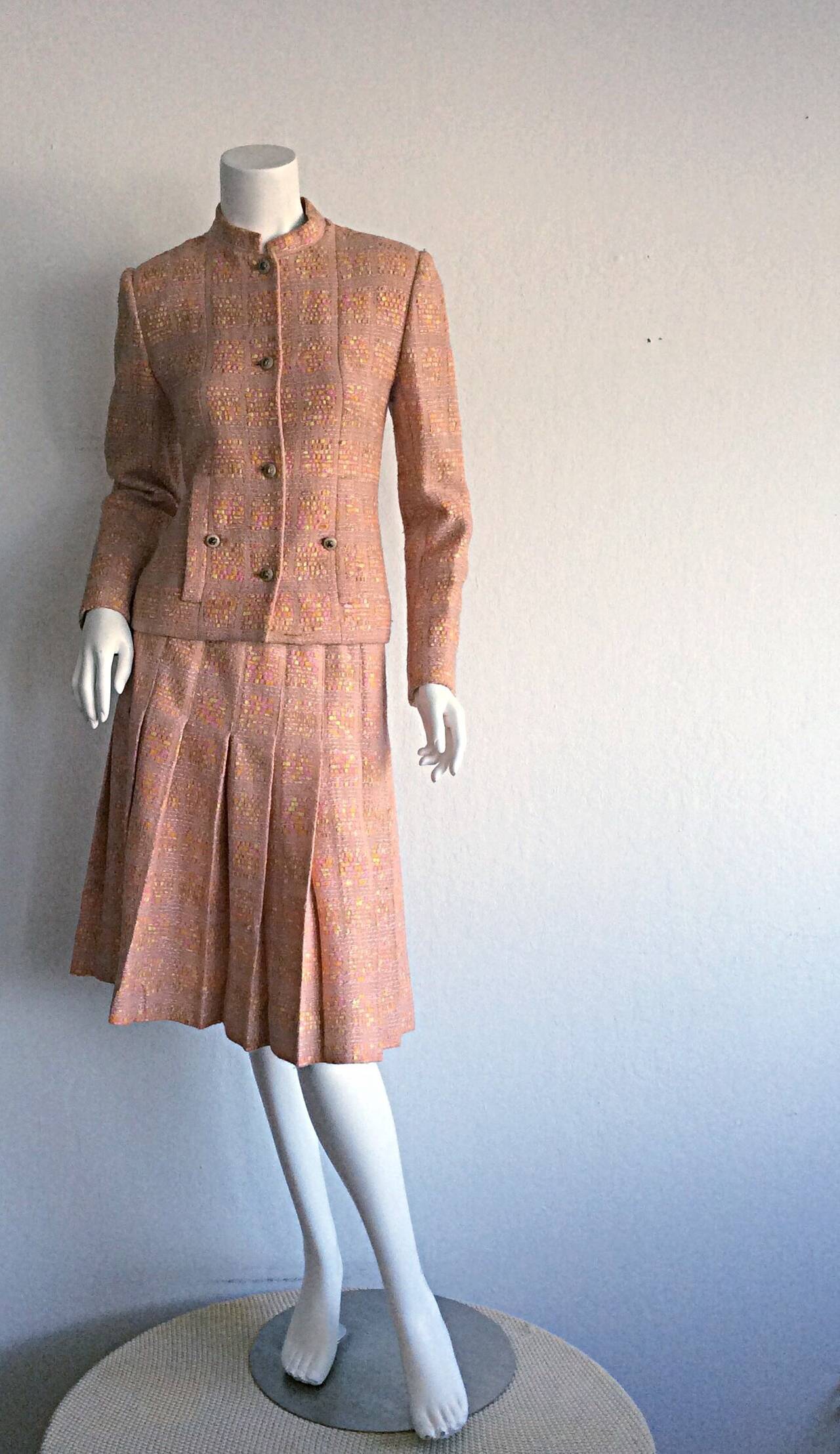 Amazing vintage 1960s Chanel suit, that was custom made for the Irish ambassador's wife (at the time). Hand-finished construction constitutes this lovely piece as Demi-Couture. Wonderful silk boucle, with light pink as the primary color. Incredibly