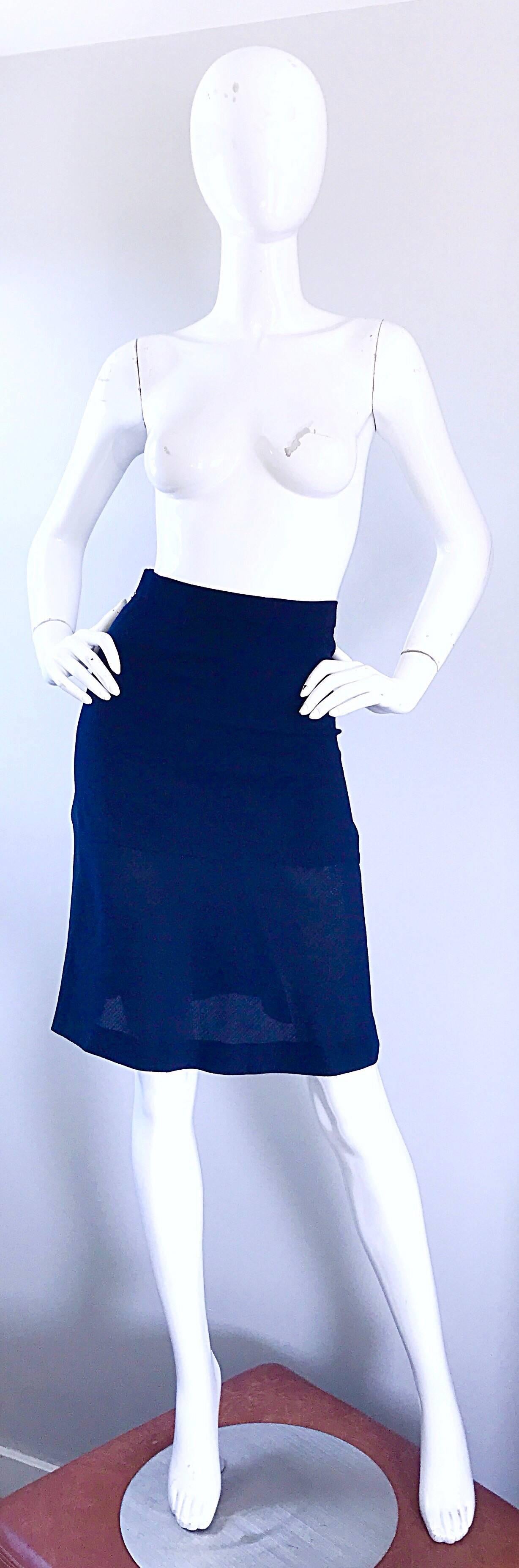 Chic and classic vintage CHANEL, by KARL LAGERFELD 1990s navy blue virgin wool flounce hem high waisted skirt! Features a soft virgin wool, and is halfway lined to provide the slightest sheer illusion. Hidden zipper up the back with hook-and-eye