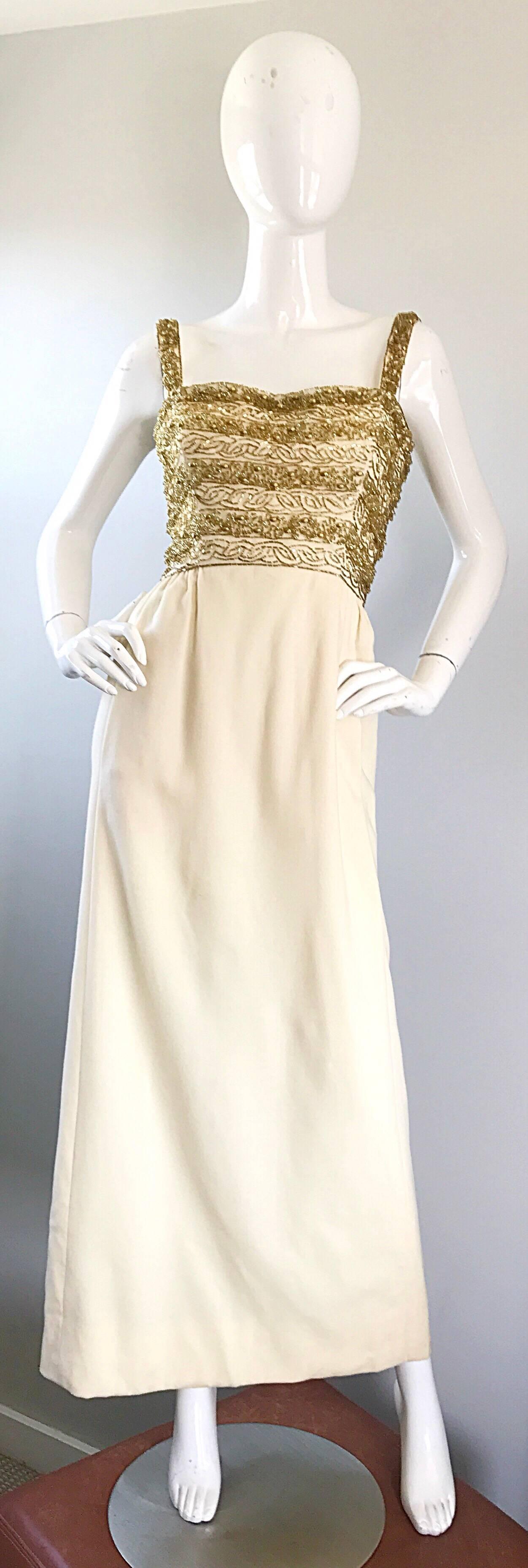 Gorgeous 1960s JOSEPH MAGNIN ivory / winter white and gold beaded couture virgin wool full length evening dress! Features thousands of hand-sewn gold beads of all different sizes on the front and back of the fitted bodice. Features POCKETS at each