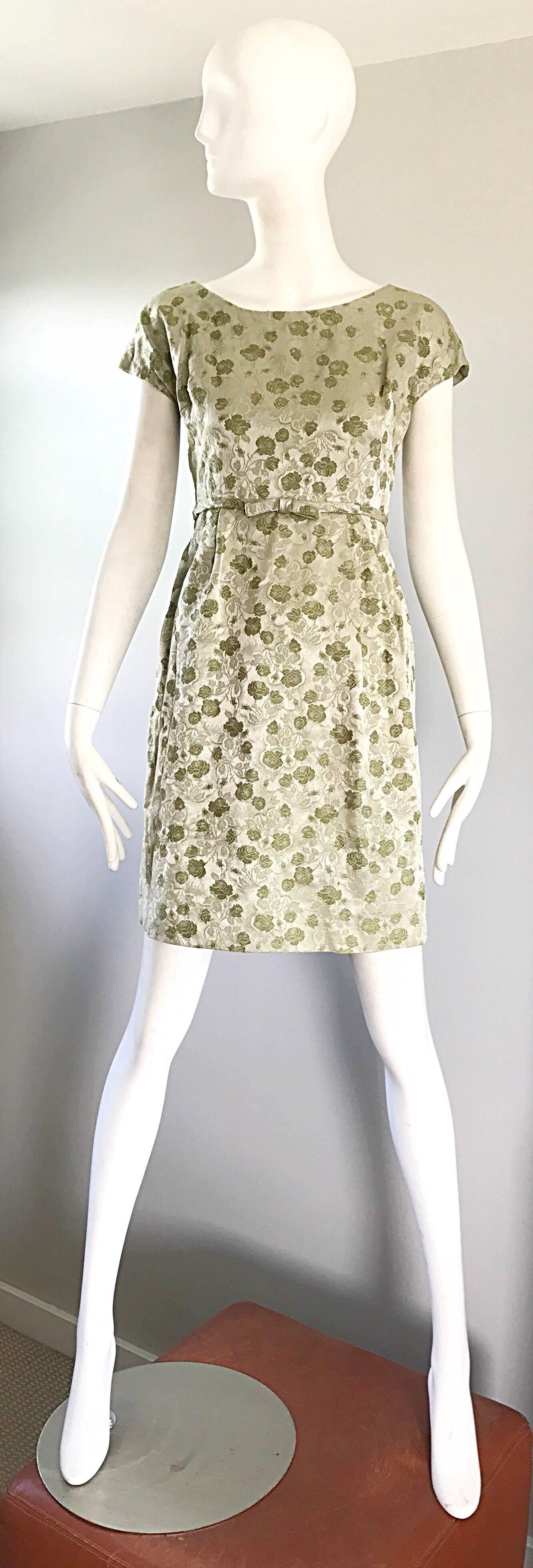 Beautiful late 1950s demi couture avocado green silk brocade cap sleeve dress! Features a floral silk brocade pattern. Lots of attention to detail, with hand-sewn finishings. Full metal zipper up the back with hook-and-eye closure. Attached bow belt