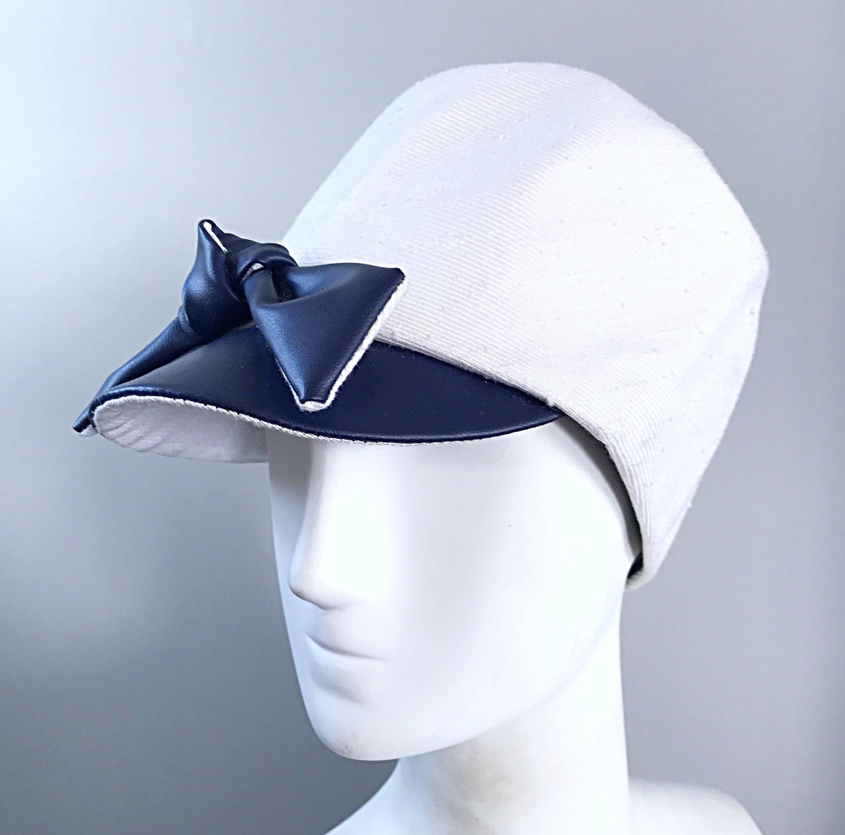 Beyond chic 1960s OLEG CASSINI navy blue and white linen and silk blend nautical hat! The white section features a linen and silk blend that retains its' shape nicely. Navy blue faux leather brim and bow. Looks great with jeans or a dress. In great