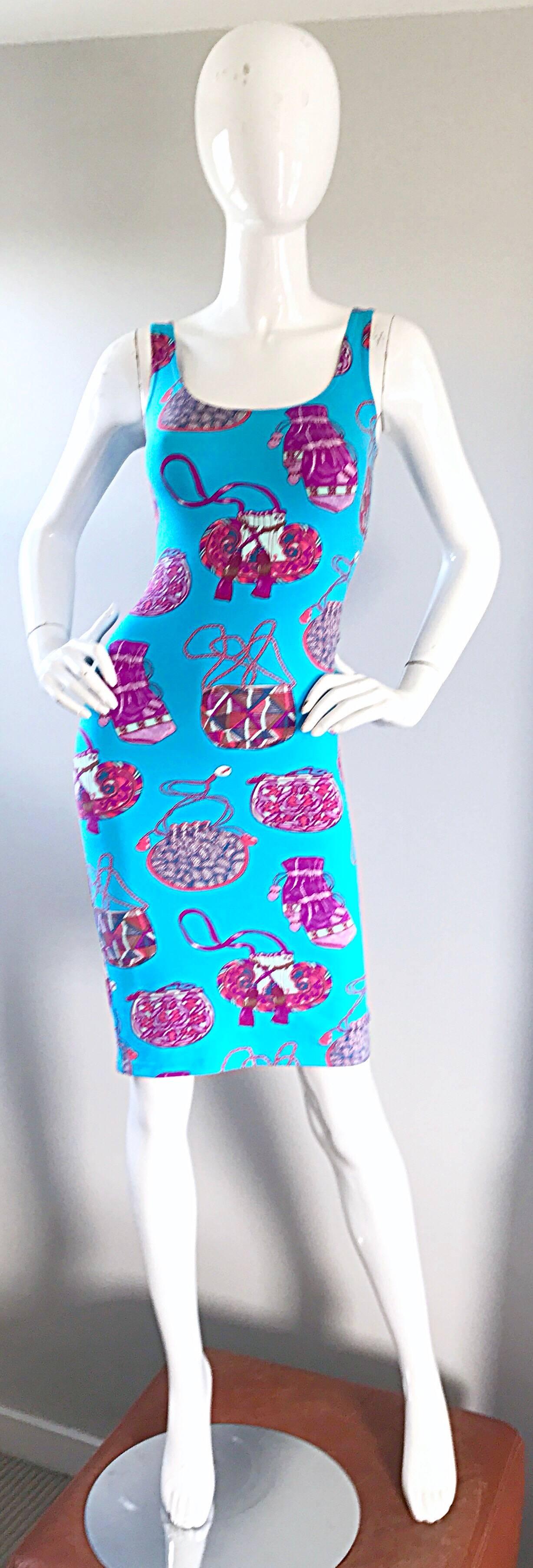 Brand new with tags vintage 90s MANUEL CANOVAS sleeveless purse print novelty bodcon dress! Features a stretchy turquoise blue stretch rayon fabric. Vibrantly colored purses / bags printed in hot pink, pink and fuchsia throughout. Simply slips over