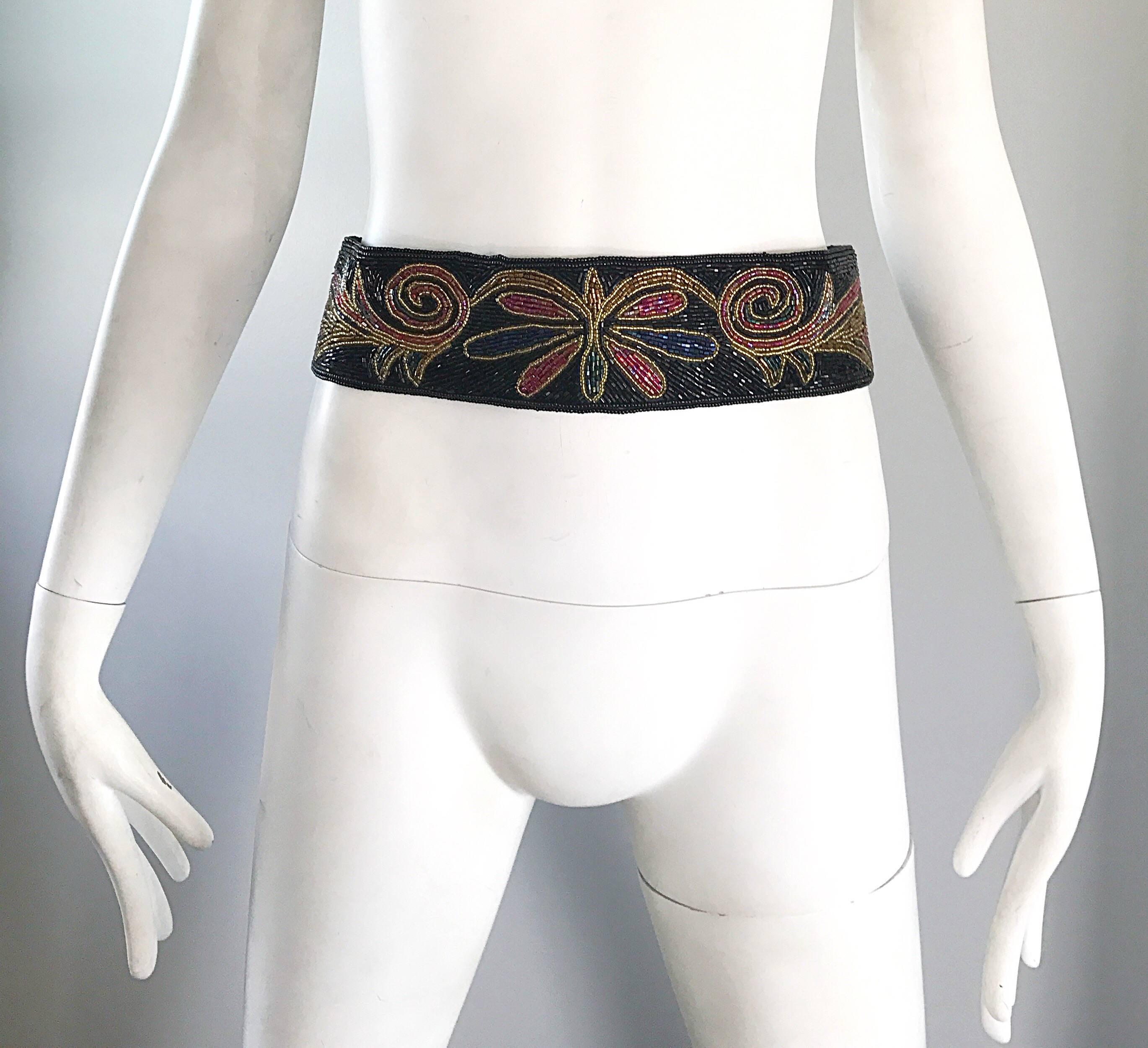 Fabulous 1980s fully beaded 'butterfly' belt! Features thousands of hand-sewn seed beads, with a butterfly motif in the front center. Vibrant colors of red, pink, blue, green and gold throughout. Hidden Velcro closure in the back makes this beauty