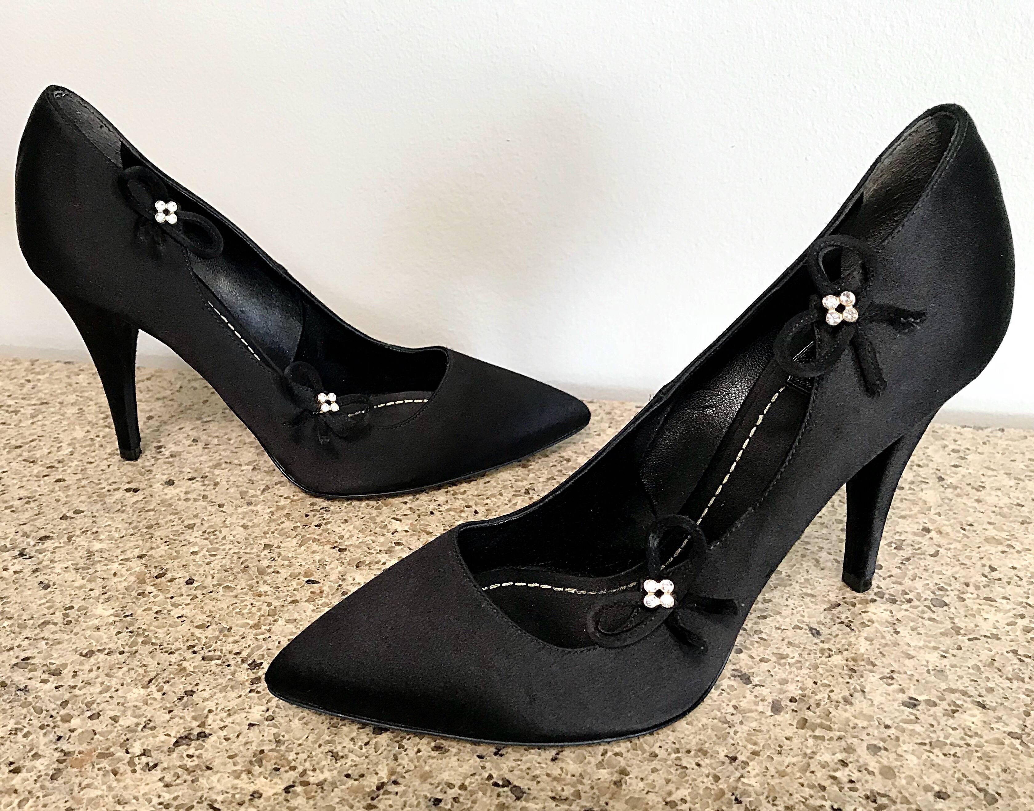 Gorgeous CHRISTIAN DIOR by JOHN GALLIANO black silk satin high heels / pumps! These shoes offer so much more than just a basic black shoe! Features an elegant pointy toe. Rhinestone flower details on each shoe. Great with a dress, gown, jeans, or a