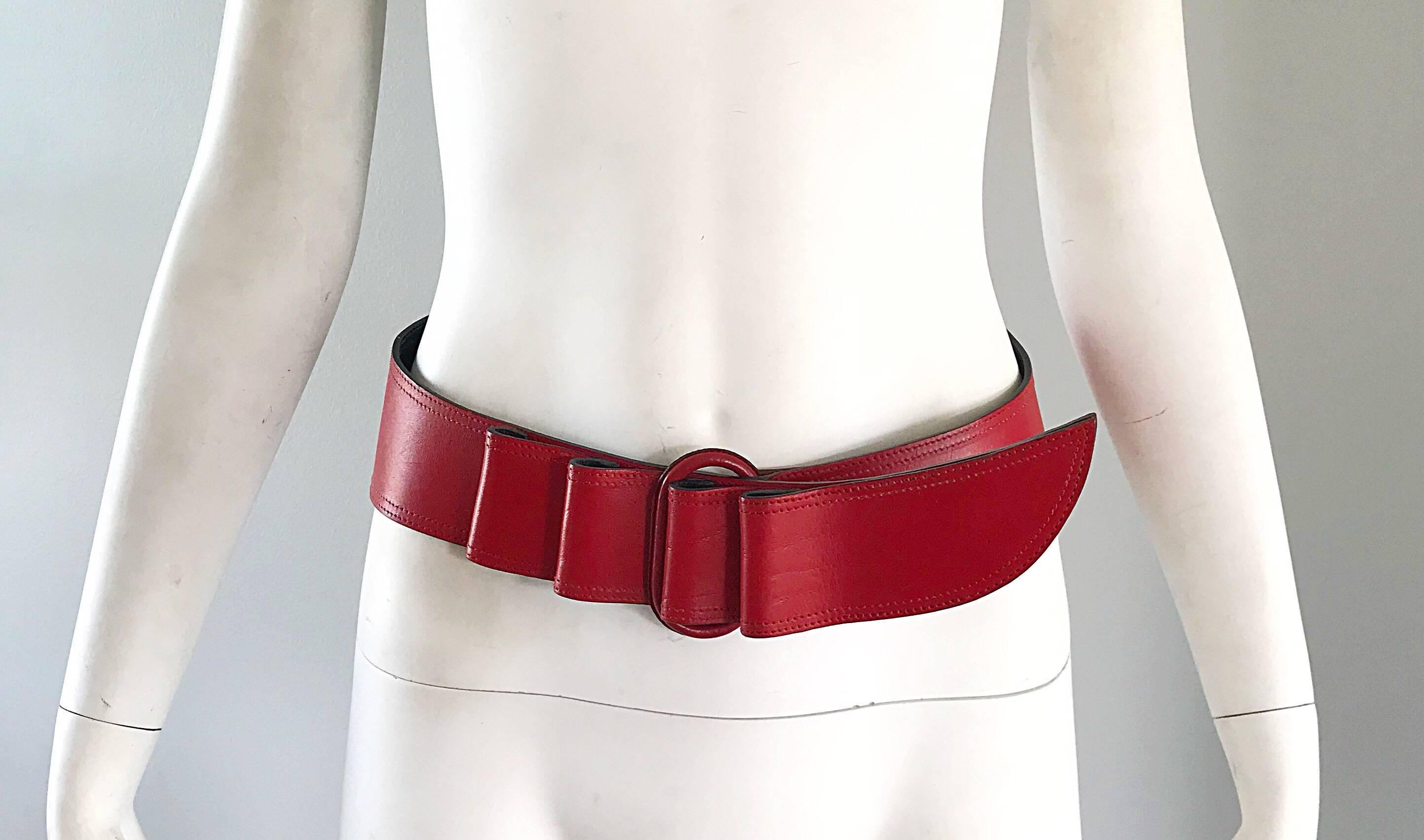 Rare vintage mid 1980s CALUDE MONTANA lipstick red oversized Avant Garde leather belt! Shaped like a machete, this piece of fashion history offers so much style! Raised leather notches can be looped to fit an array of sizes. Looks great over a