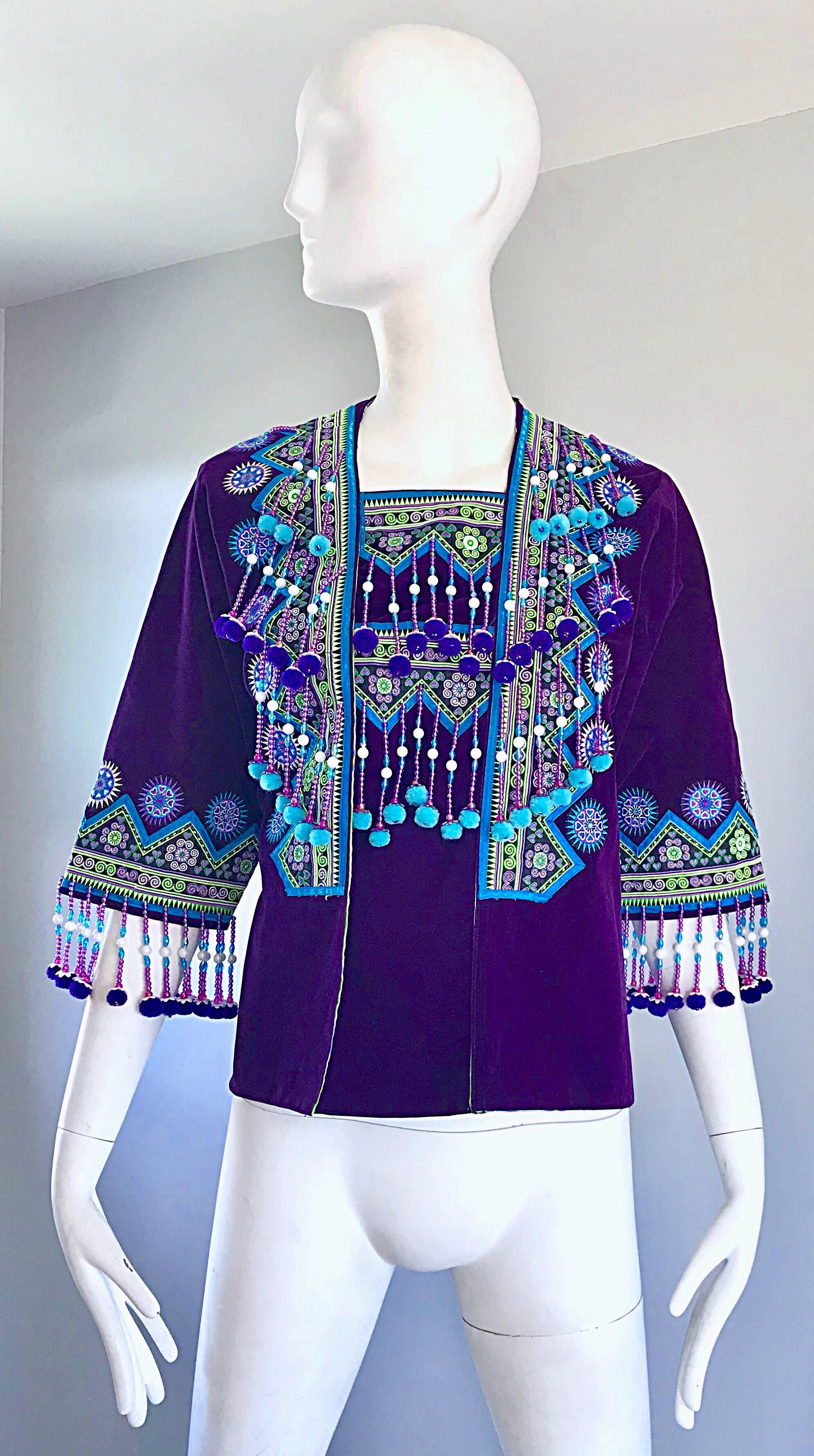 Amazing 1970s rich purple boho ethnic beaded Hmong inspired kimono style jacket! Features a luxurious regal purple on soft cotton velvet. Colorful embroidery throughout. Beaded fringe throughout the front bodice, at sleeves, and across the top back.
