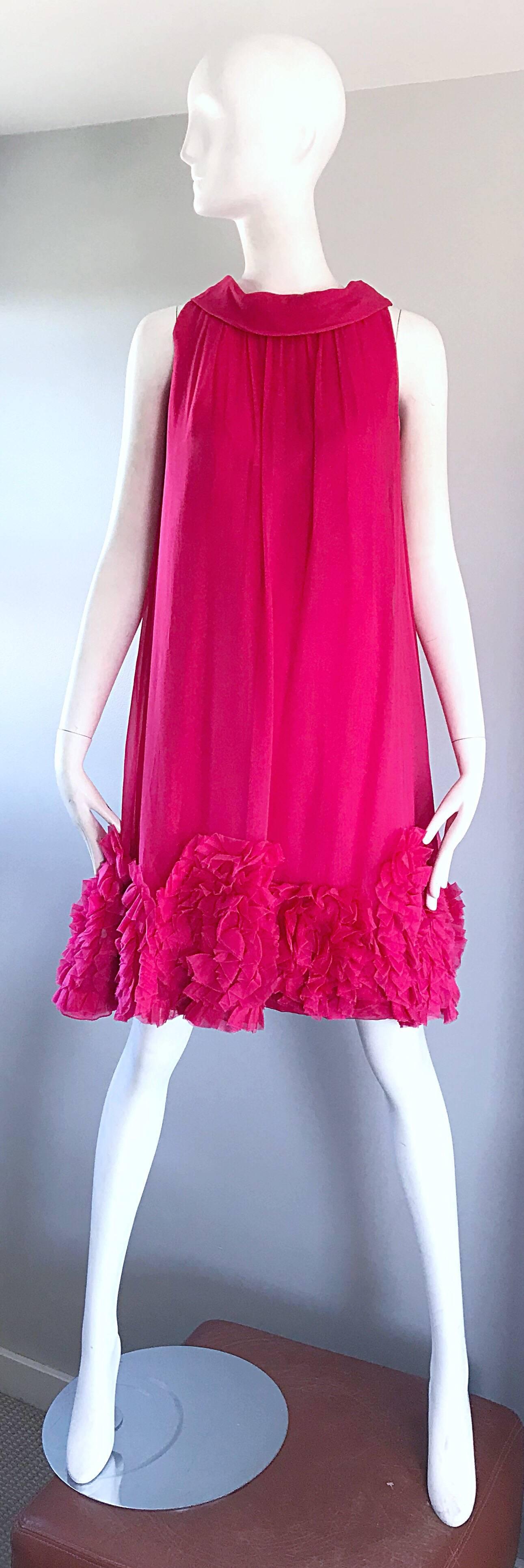 Phenomenal vintage 60s hot pink silk chiffon trapeze empire waist babydoll dress! Features a high neck, with a trapeze fit. Ruffle details at the hem. Full metal zipper up the back with hook-and-eye closure. Amazing attention to detail on this