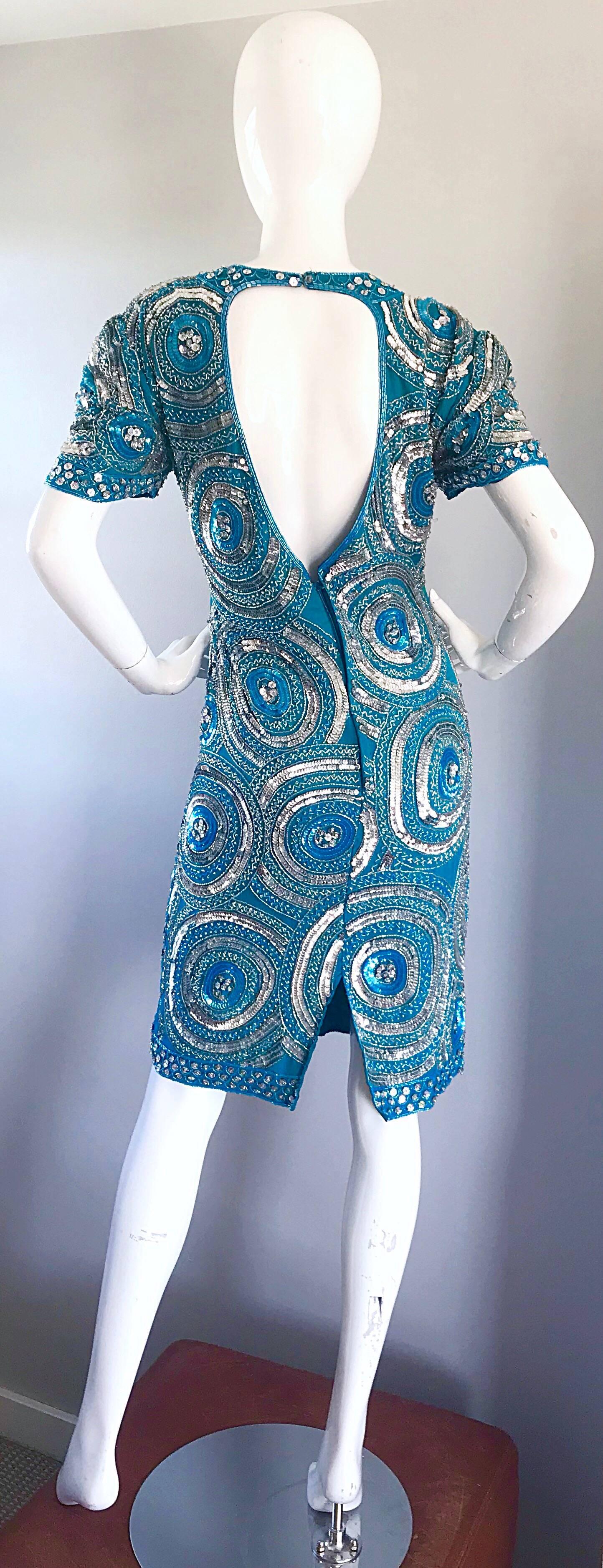 Gorgeous larger size vintage turquoise blue and silver fully sequined open back silk cocktail dress! Features thousands of hand-sewn silver and turquoise blue sequins and beads throughout. Circular patterns. Flattering open back reveals just the