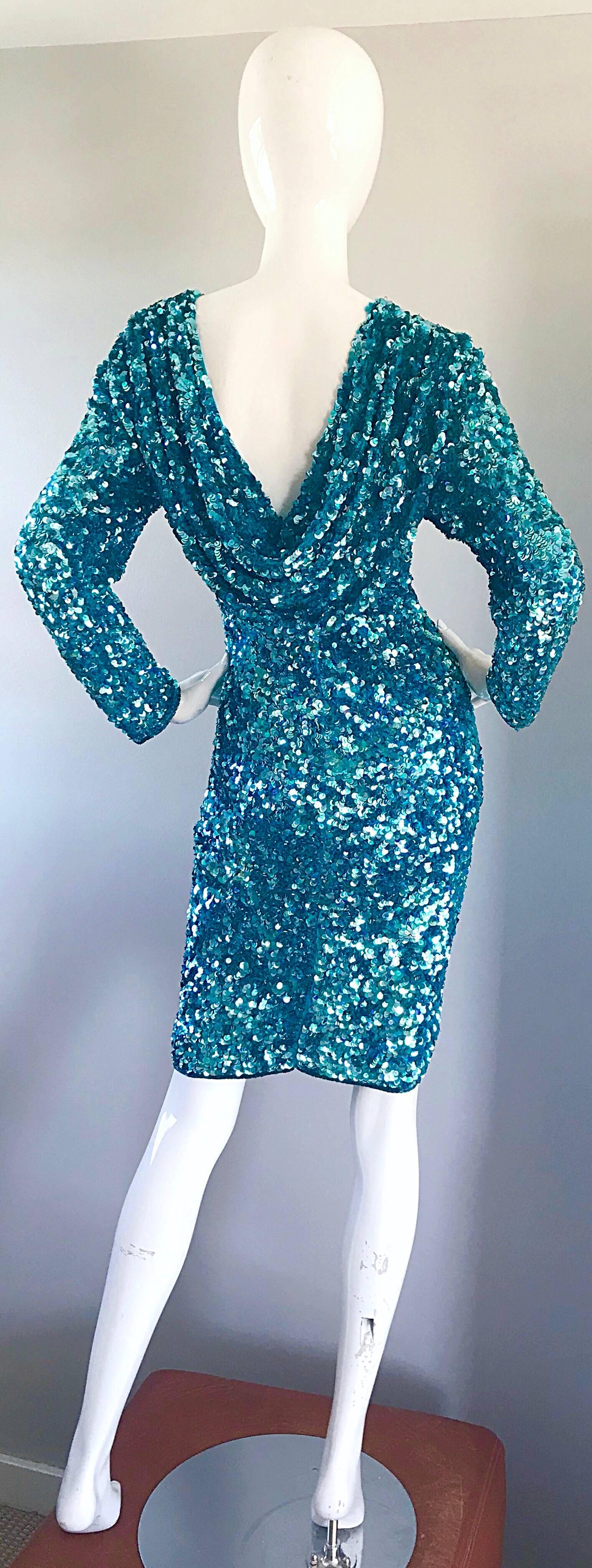 Gorgeous vintage larger size early 1990s turquoise blue fully sequined long sleeve silk chiffon dress! Features thousands of hand-sewn sequins throughout. Flattering lower cut back features and elegant drape. Turquoise blue seed beads line the neck