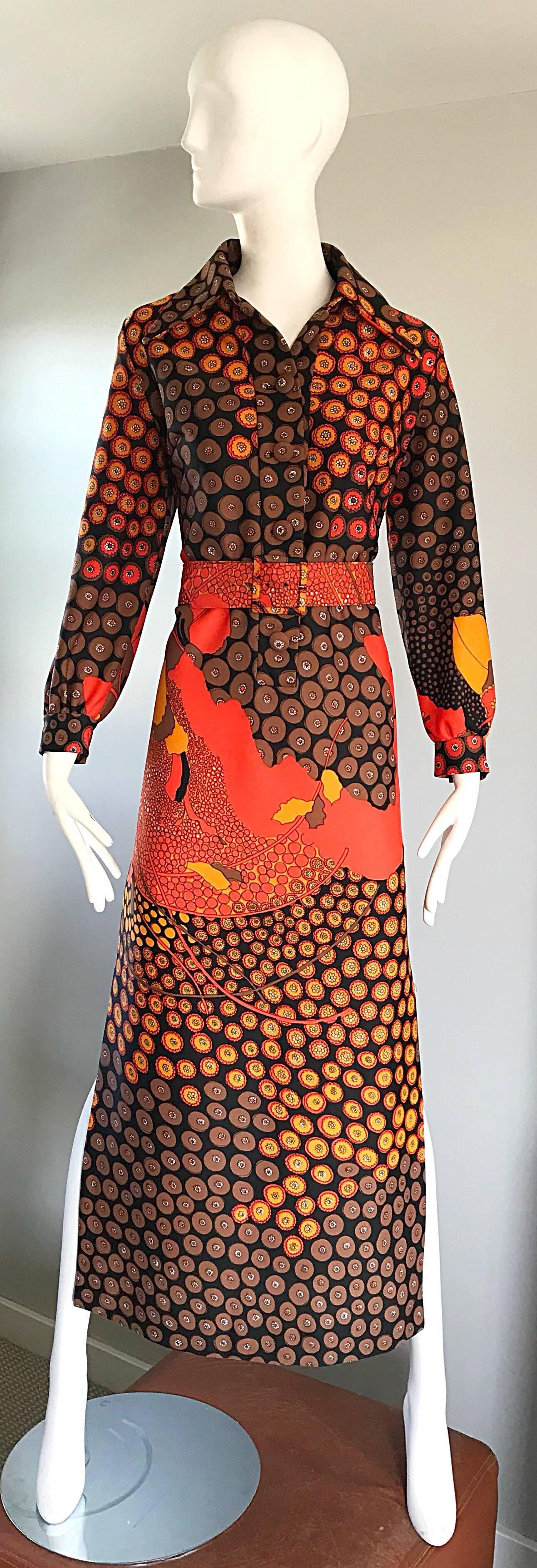 Amazing 1970s ROOS ATKINS abstract belted boho knit maxi dress! Features vibrant hues of orange, yellow, brown and black throughout. Wonderful tailored bodice features fabric covered buttons up the front. Long sleeves also feature buttons at each