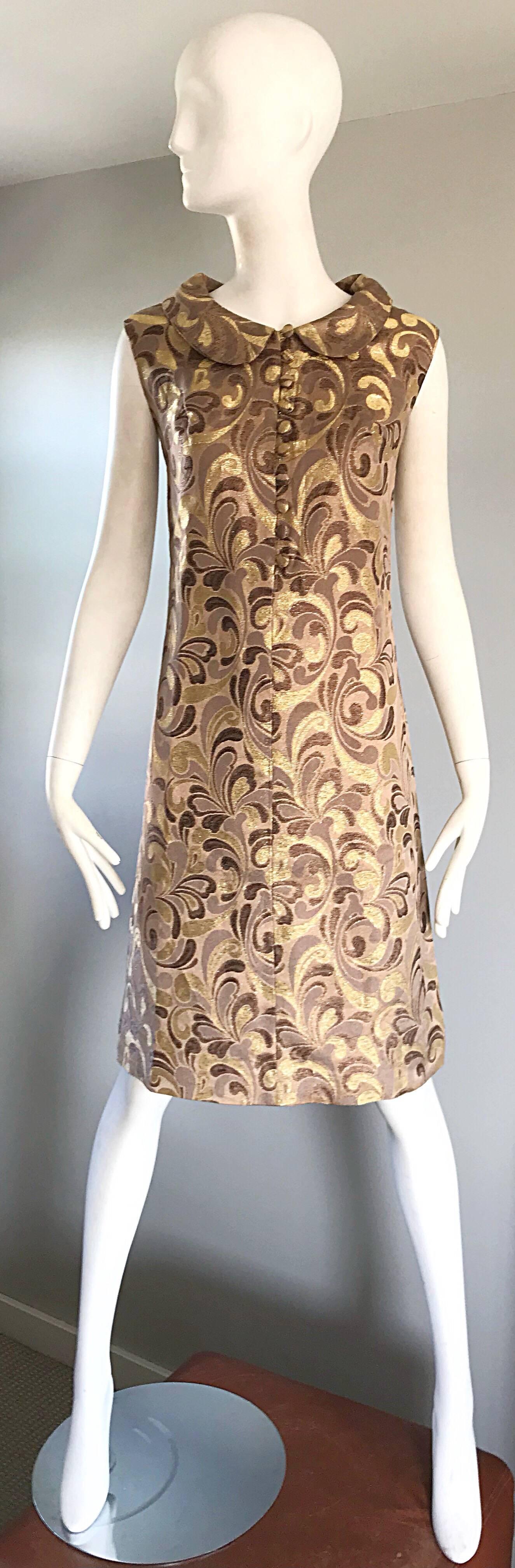 Beautiful 1960s gold, brown metallic and taupe silk brocade demi couture shift dress! Features a fitted bodice, with a slight A-Line skirt. Ten fabric covered mock buttons up the bodice, with a Peter Pan collar. Full metal zipper up the back with