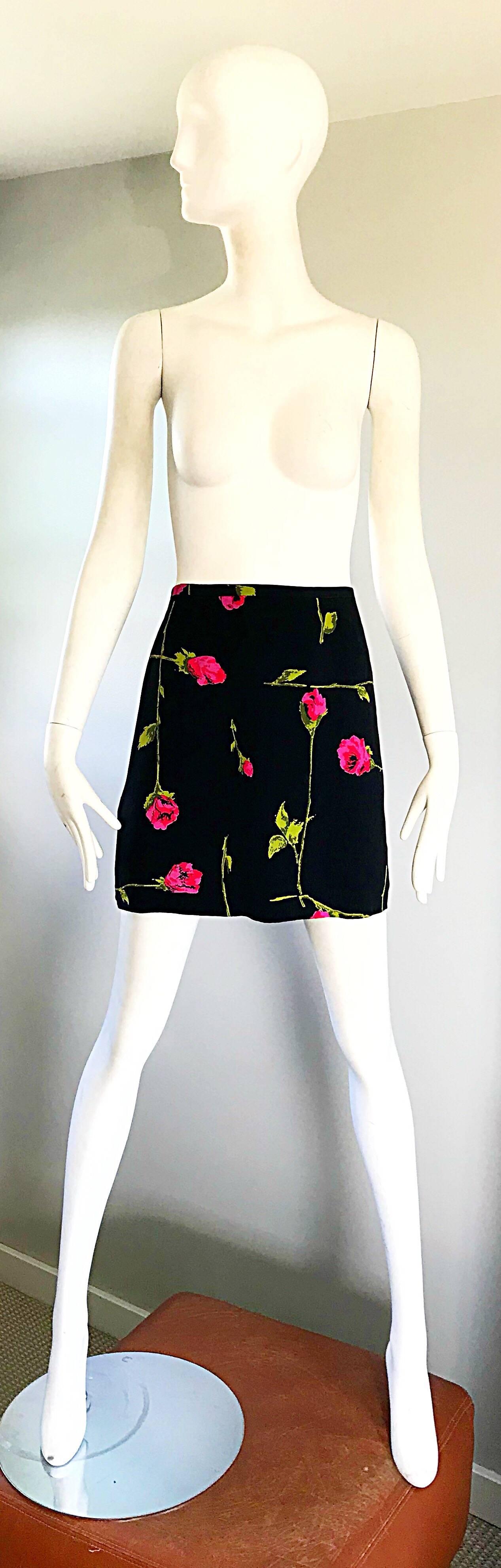 Early 1990s BETSEY JOHNSON black, hot pink and green rose print rayon low rise mini skirt! Features asymmetrical rose prints in different sizes throughout. Fully lined, with hidden side zipper with hook-and-eye closure. Can easily be dressed up or