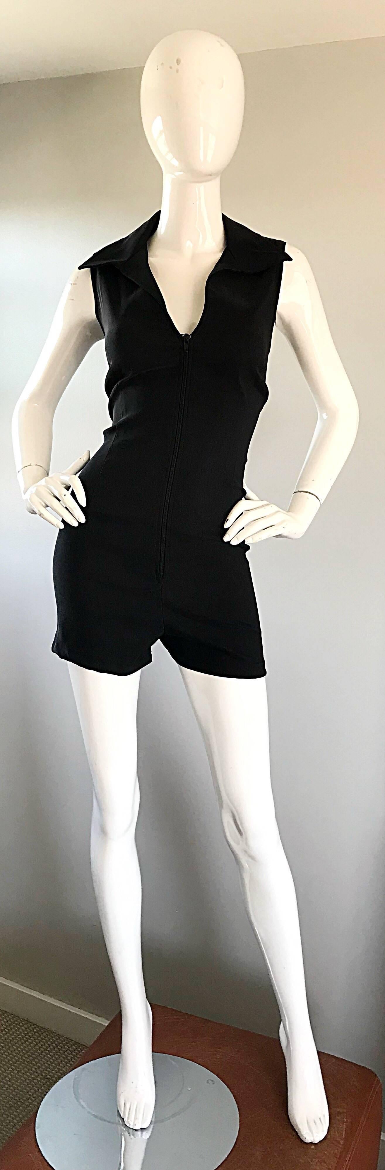 90s does 70s black one piece romper onesie! Features a hidden zipper up the front to adjust cleavage exposure. Exaggerated collar. Fabric stretches to fit. Great belted or alone, with flats, sandals, wedges, heels or boots. In great condition.