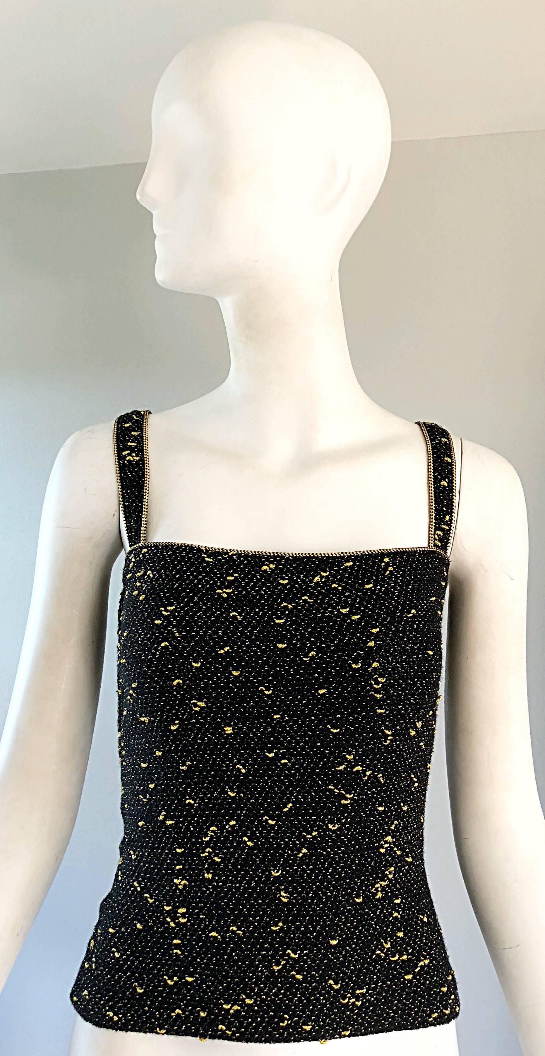 Sexy vintage 70s YSL black and gold metallic sleeveless shirt blouse ! Features a soft black knit stretchy fabric, with gold lurex throughout. Hidden side button holds everything in place. Can easily be dressed up or down. Great with shorts, jeans