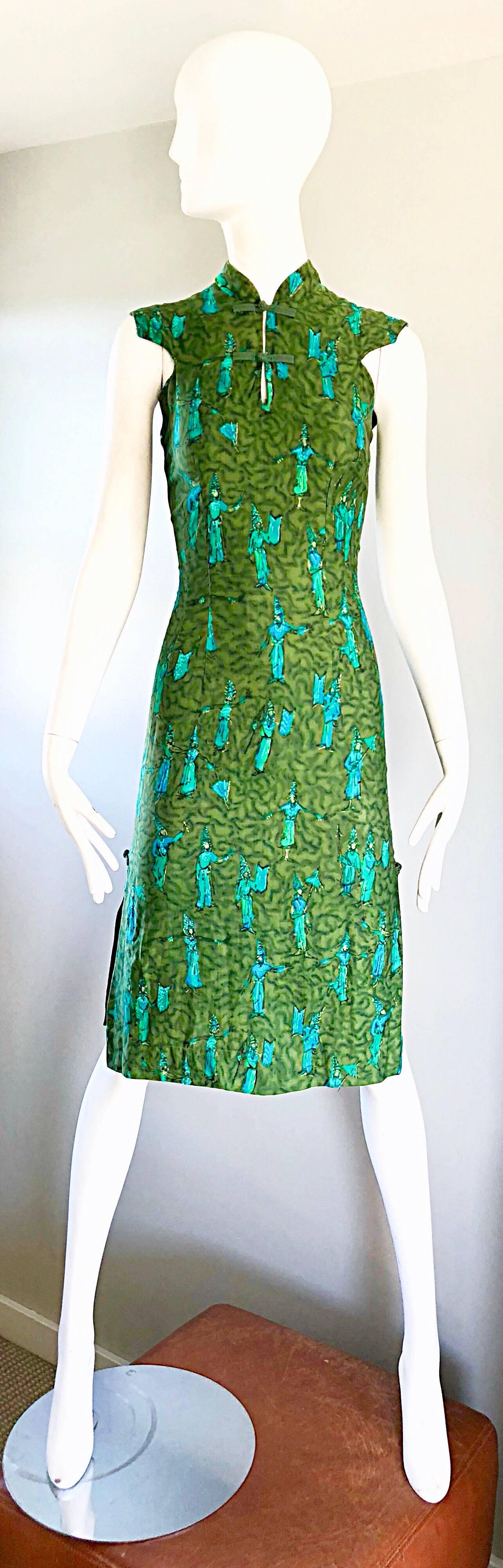 Sensational and super rare 1960s demi couture cheongsam novelty print cotton dress! Features vibrant colors of avocado green, lime / neon green and turquoise blue. Features Balinese / Polynesian / South East Asian dancers throughout. Signature knot