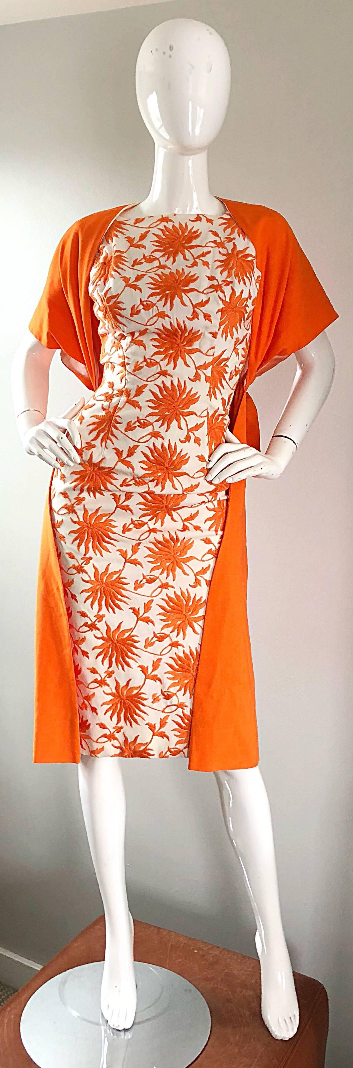 Sensational 1950s demi couture bright orange and ivory white embroidered flower sleeveless dress and short sleeve jacket! Features a fitted bodice, and wiggle body. Luxurious heavy cotton fabric. Full metal zipper up the back with hook-and-eye