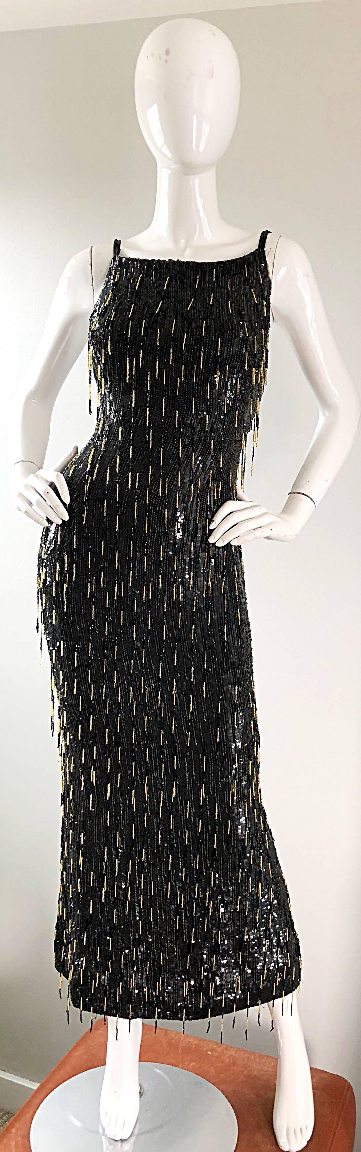 Gorgeous early 1990s ESCADA COUTURE black and gold beaded full length fringe flapper style evening dress! Features a black silk base, with thousands of hand-sewn black sequins throughout the entire dress. Hundreds of hand-sewn fringes in black and