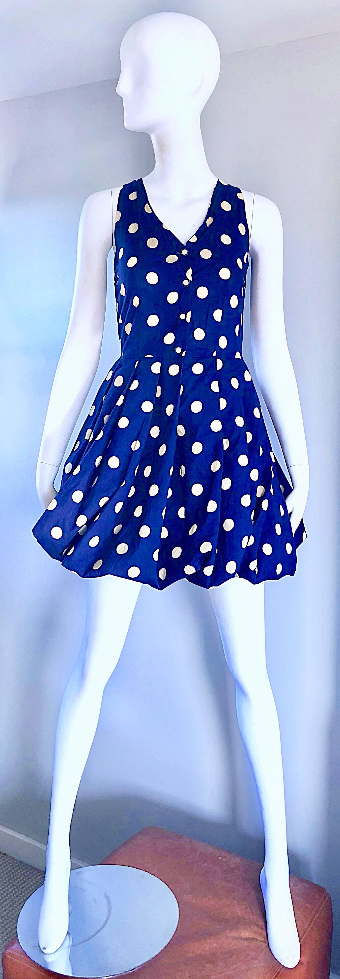 Chic 1990s SERGIO TEGON for SEVENTY navy blue and ivory white polka dot cotton sleeveless mini bubble dress! Features a fitted bodice that buttons up the front, with a full bubble skirt. Navy blue and ivory white polka dots throughout. Interior band